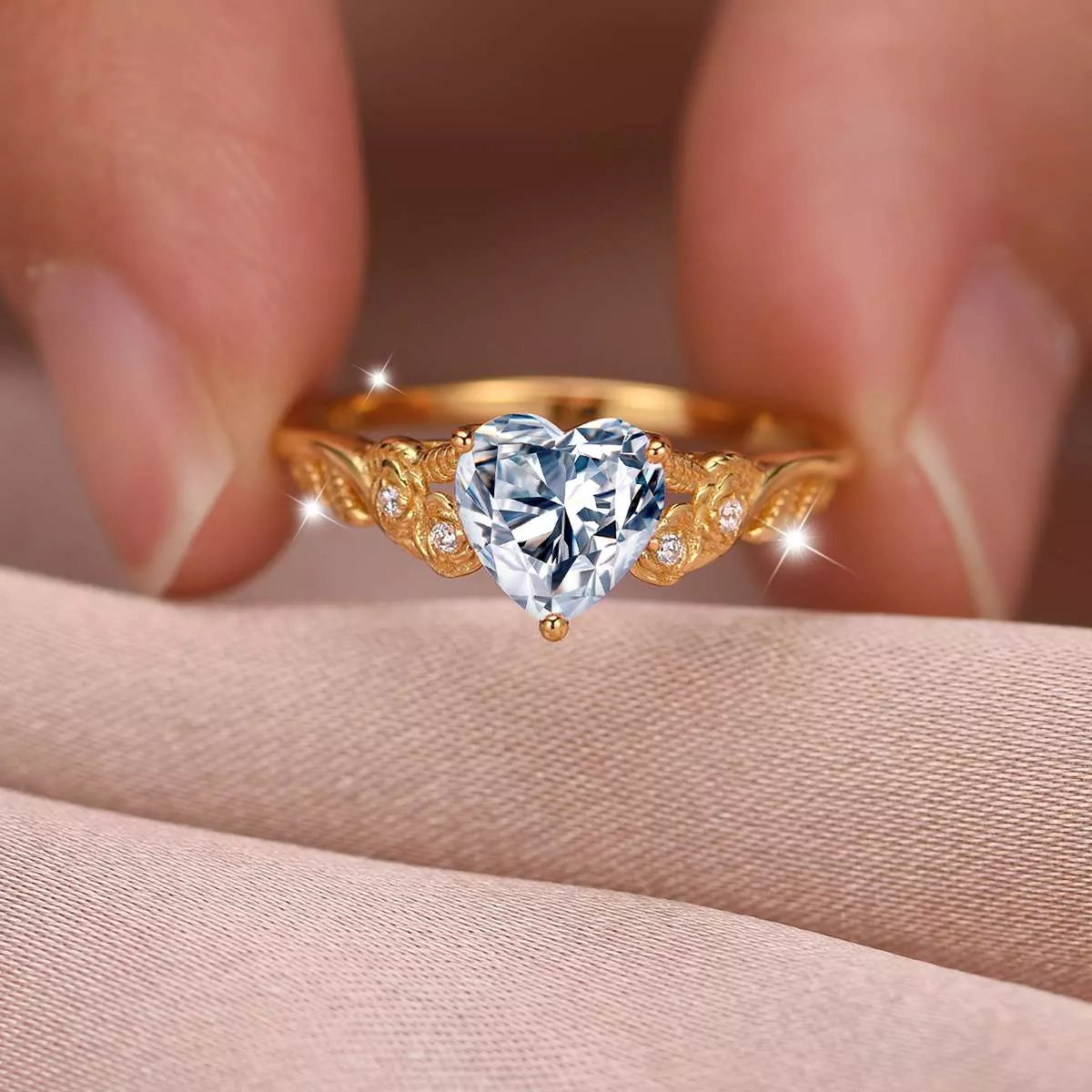 Close-up of a gold heart-shaped moissanite ring with zircon accents — romantic fine jewelry piece from A Whimsical Affair.