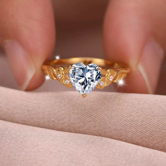 Close-up of a gold heart-shaped moissanite ring with zircon accents — romantic fine jewelry piece from A Whimsical Affair.