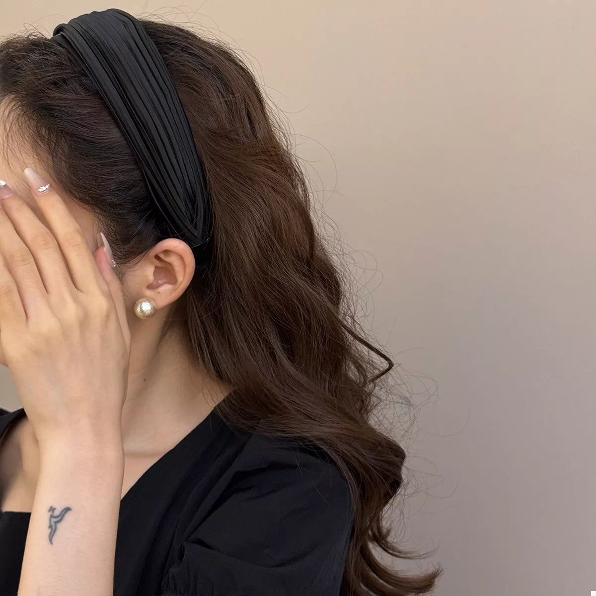 Woman wearing the Everyday Elegance Pleated Headband in Black