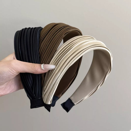 Set of three pleated headbands in black, brown, and beige, displayed together