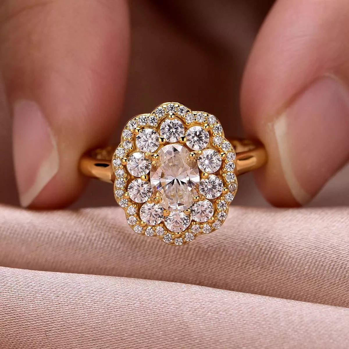 Gold-plated floral halo moissanite ring with oval center stone and layered petals of sparkling gems.