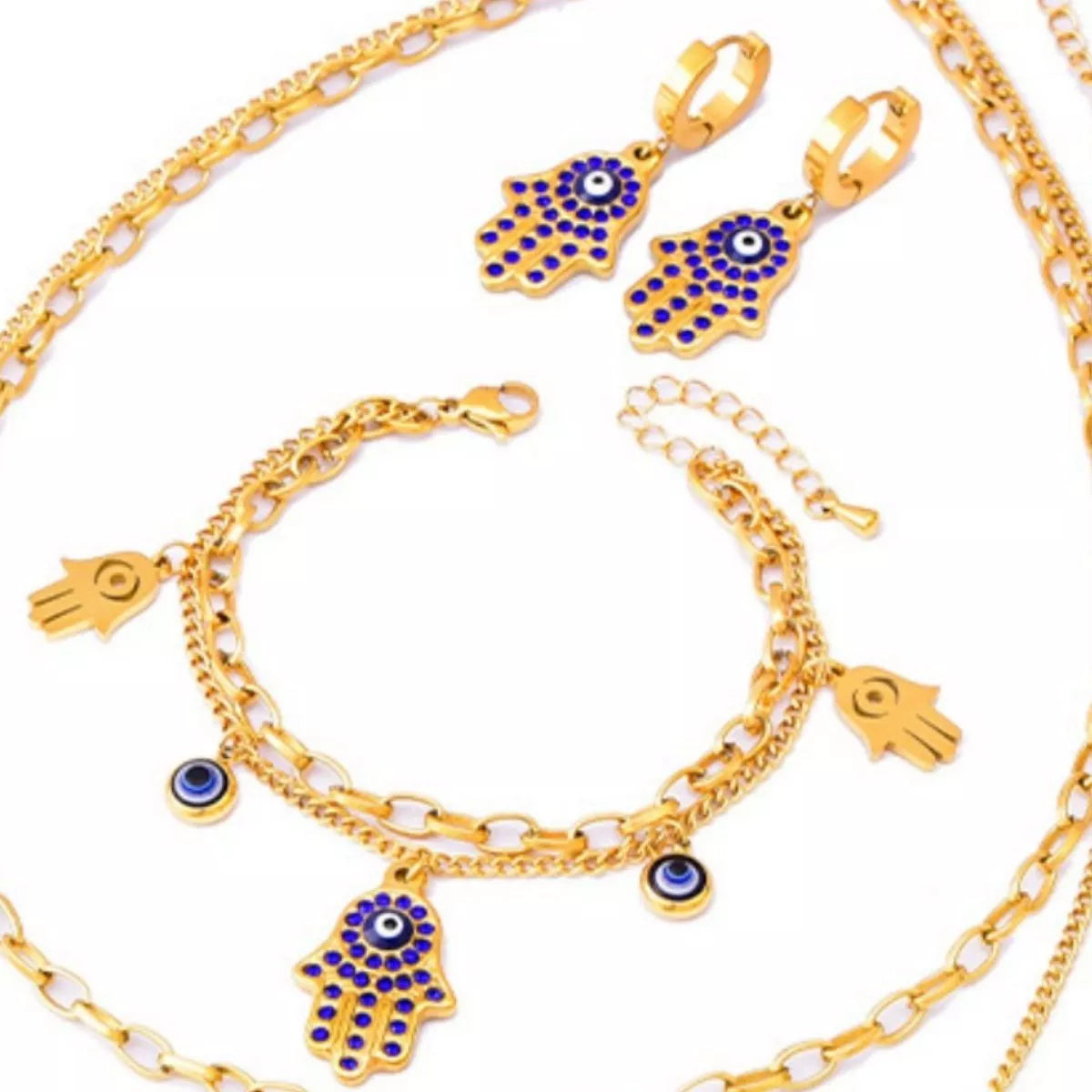 Gold-plated 3-piece jewelry set featuring a Hamsa hand charm bracelet, matching Hamsa earrings, and Evil Eye accents with blue zircon detailing on a white background.