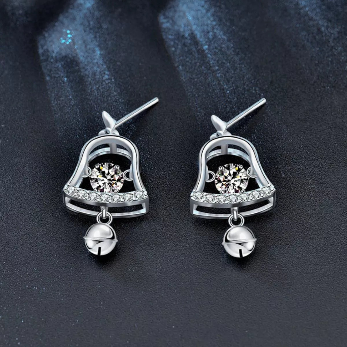 Pair of platinum-plated sterling silver bell earrings with 0.5ct moissanite center stones and dangling jingle bells.