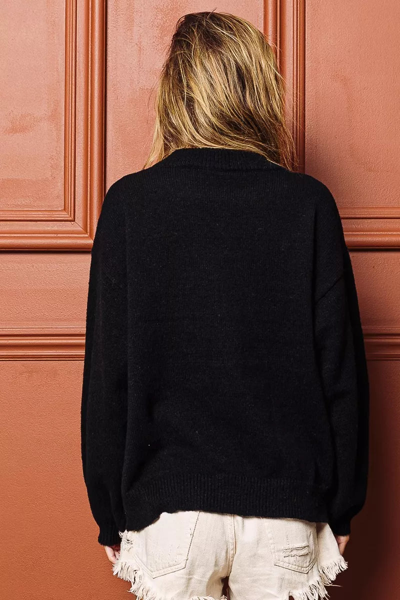 Festive tinsel lettering Christmas sweater in black with multicolor script