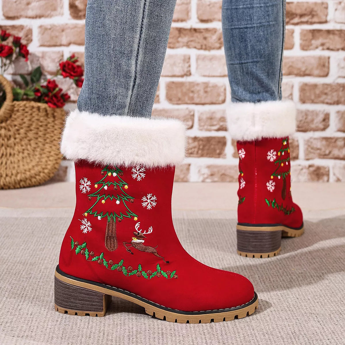 Red suede Christmas boots with faux-fur cuffs, embroidered reindeer, Christmas trees, holly, and snowflakes.