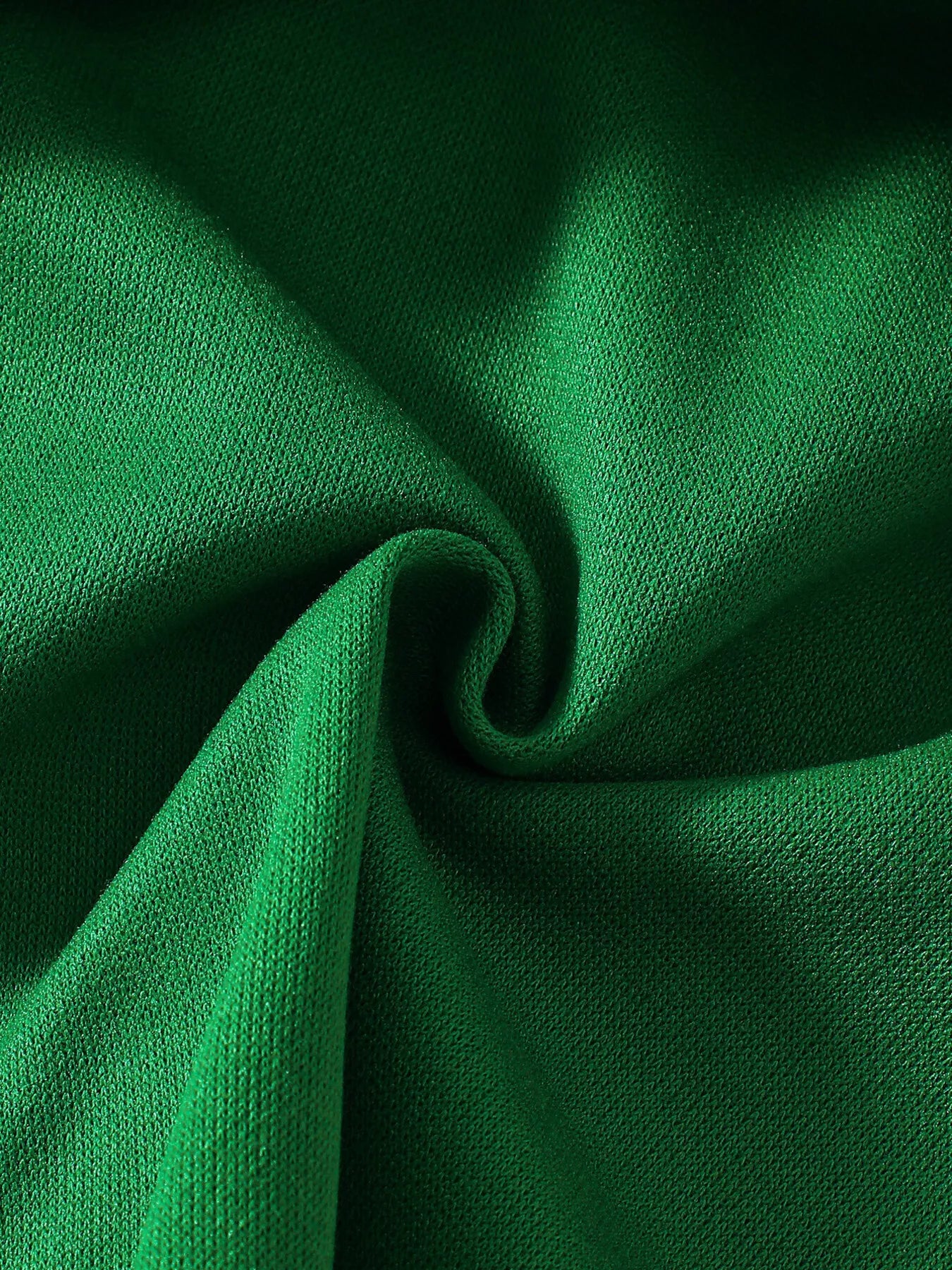 Green Christmas hooded cape for kids with “MERRY” embroidery and reindeer appliqués, pom-trim hem, displayed on holiday background.