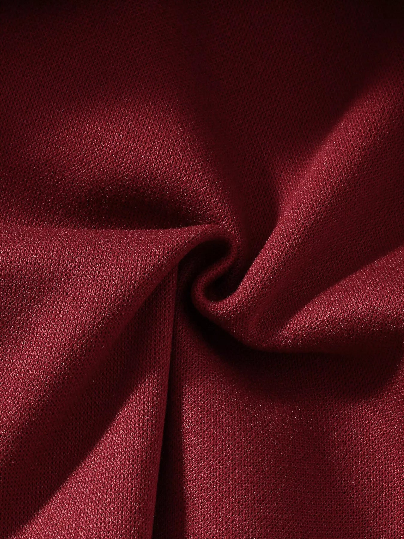 Red Christmas hooded cape for kids with “MERRY” embroidery and reindeer appliqués, pom-trim hem, displayed on holiday background.