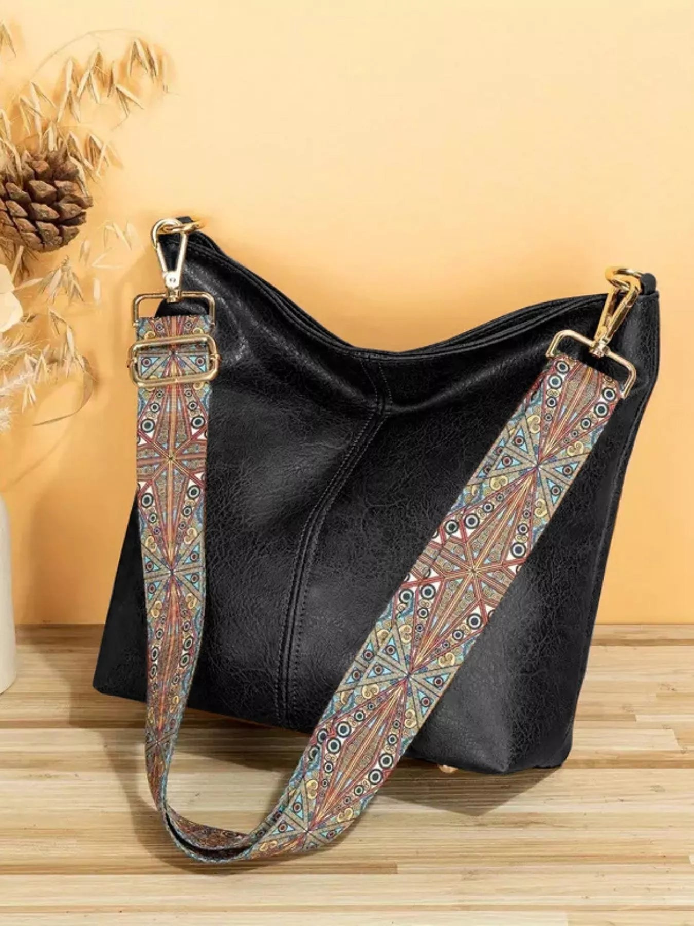 Medium PU leather tote bag with wide patterned mosaic strap and structured silhouette.
