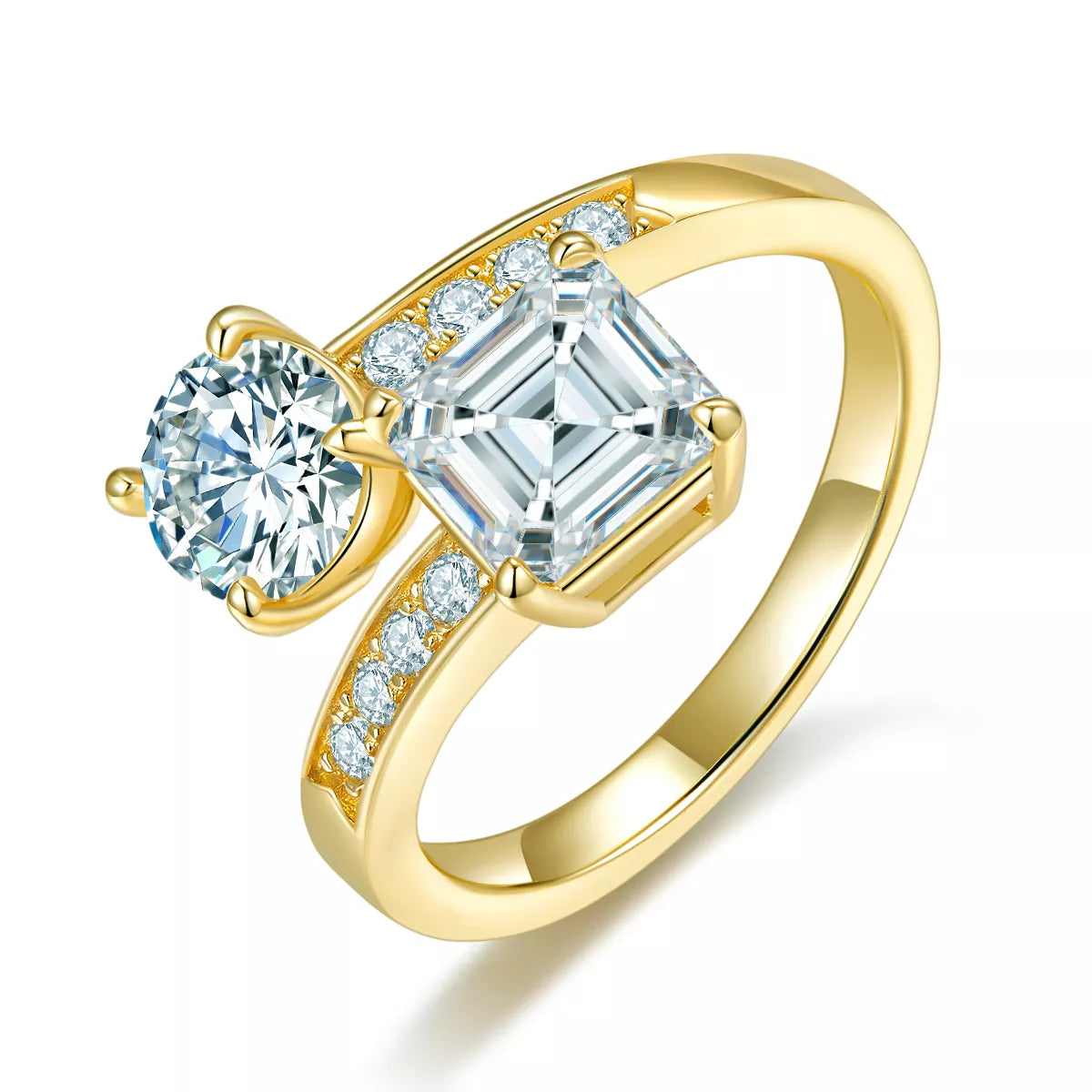 Gold-plated bypass ring with round and square moissanite stones on a light background