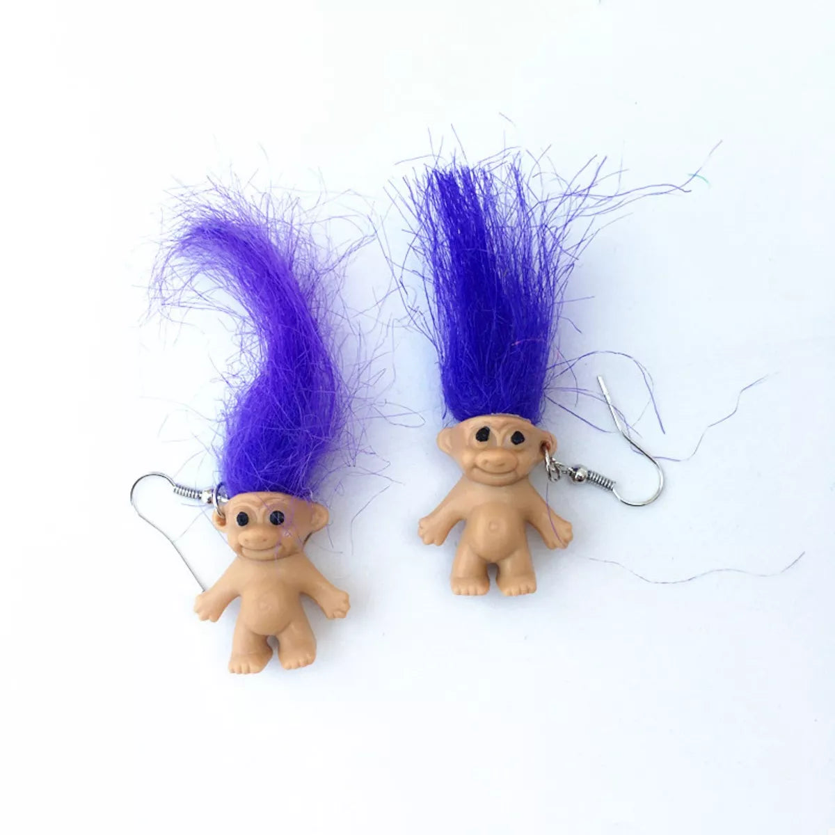 Vintage troll earrings with colorful hair and smiling doll design