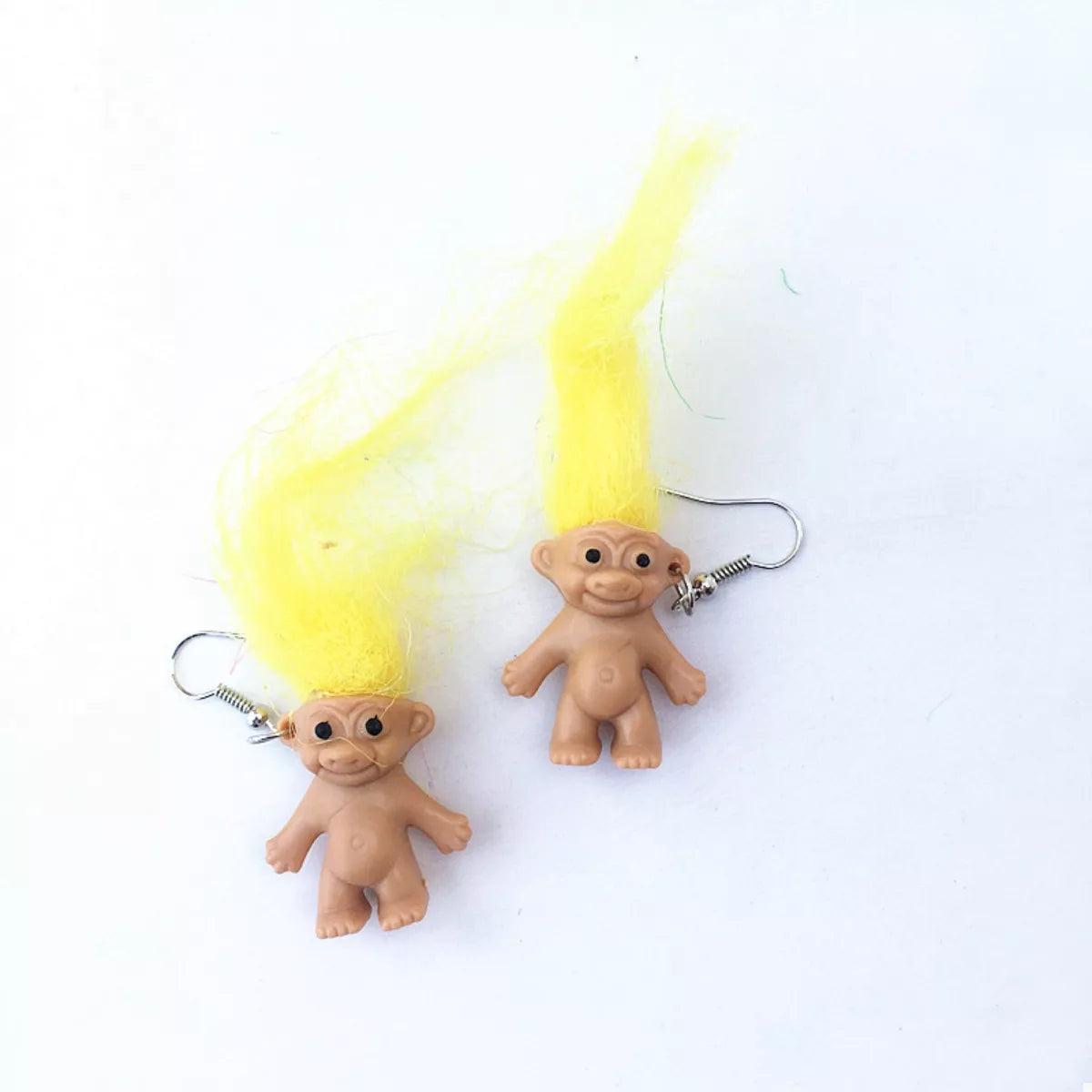 Vintage troll earrings with colorful hair and smiling doll design