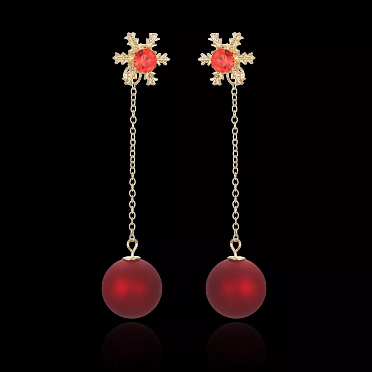 Festive red bauble drop earrings with snowflake studs and gold chain detailing.