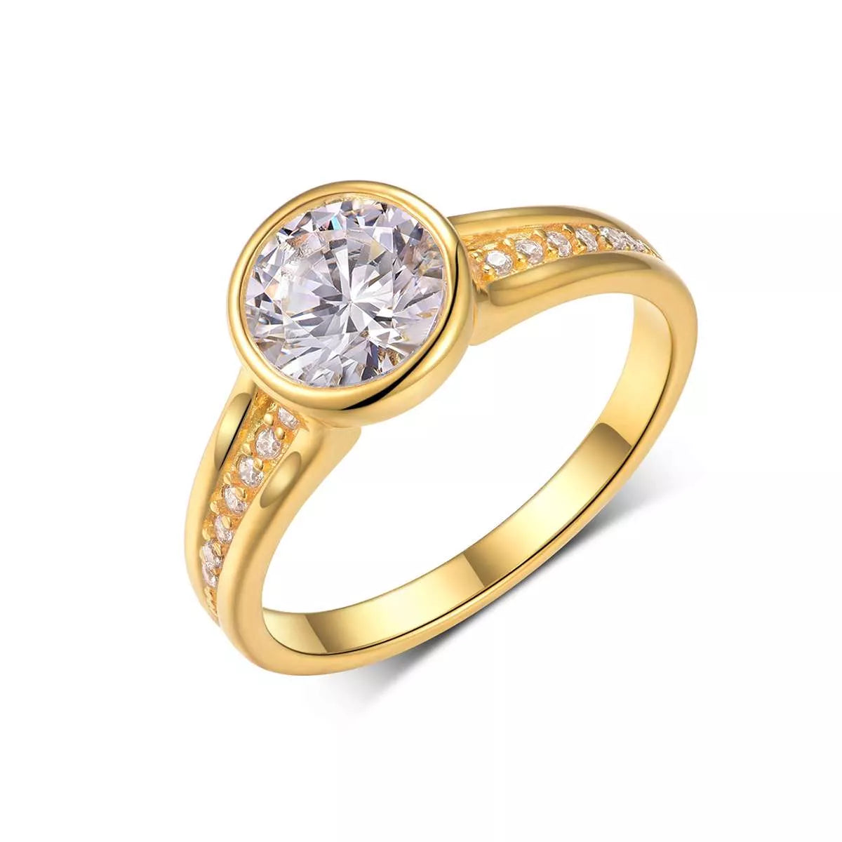 Close-up of a gold bezel-set moissanite ring with side zircon accents displayed in a blush jewelry box.