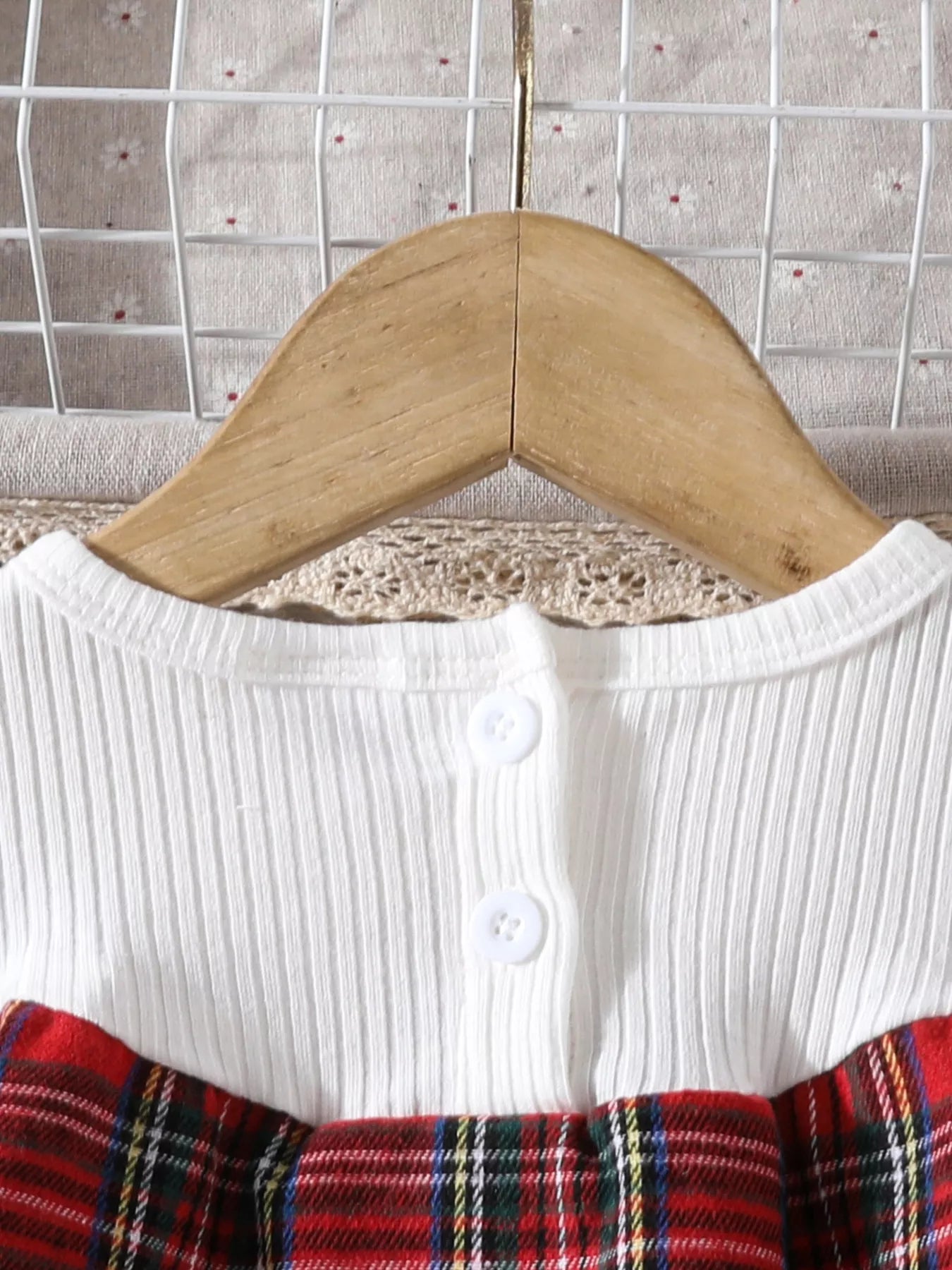 Close-up of Christmas tree embroidery and collar details on holiday tartan dress