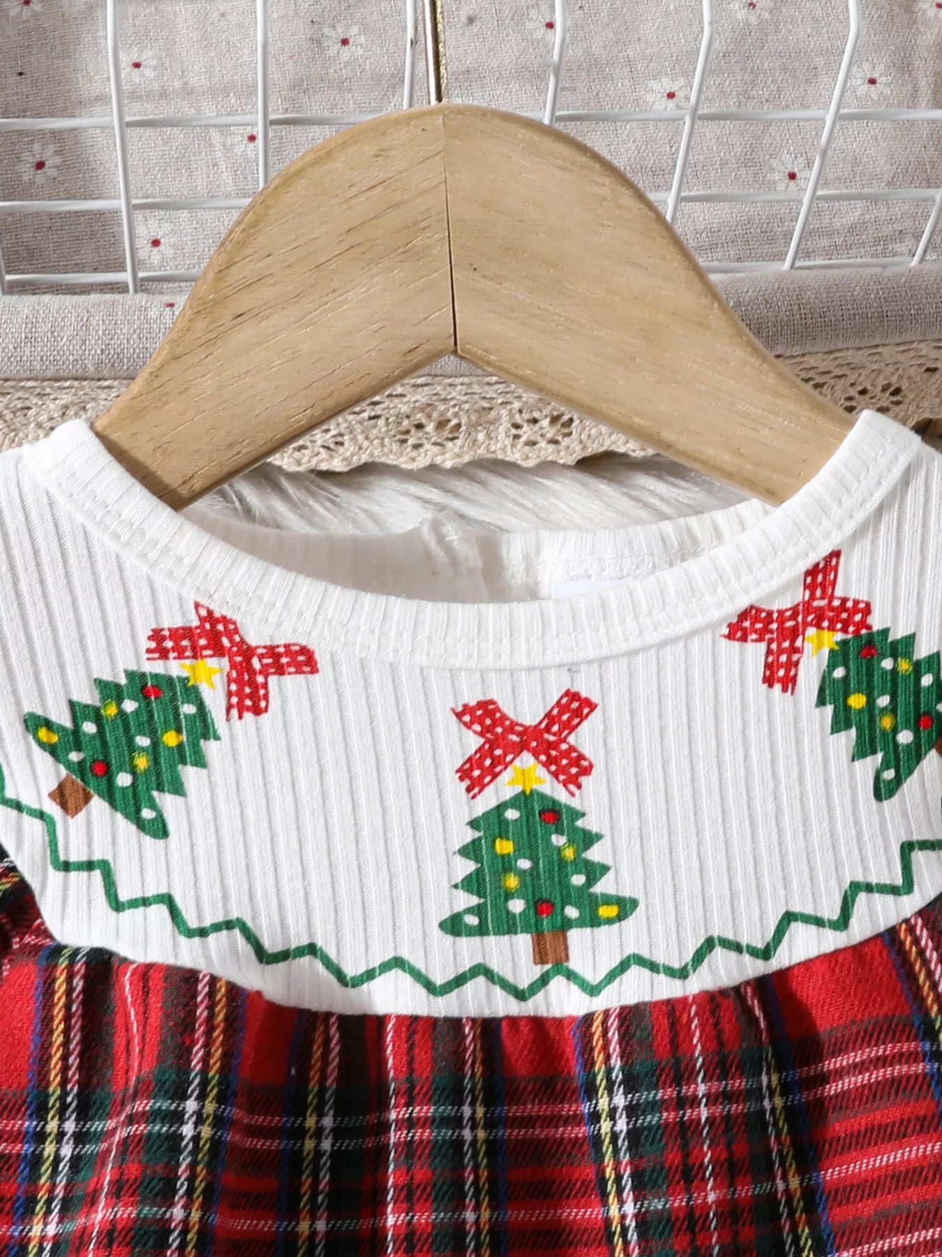 Close-up of Christmas tree embroidery and collar details on holiday tartan dress