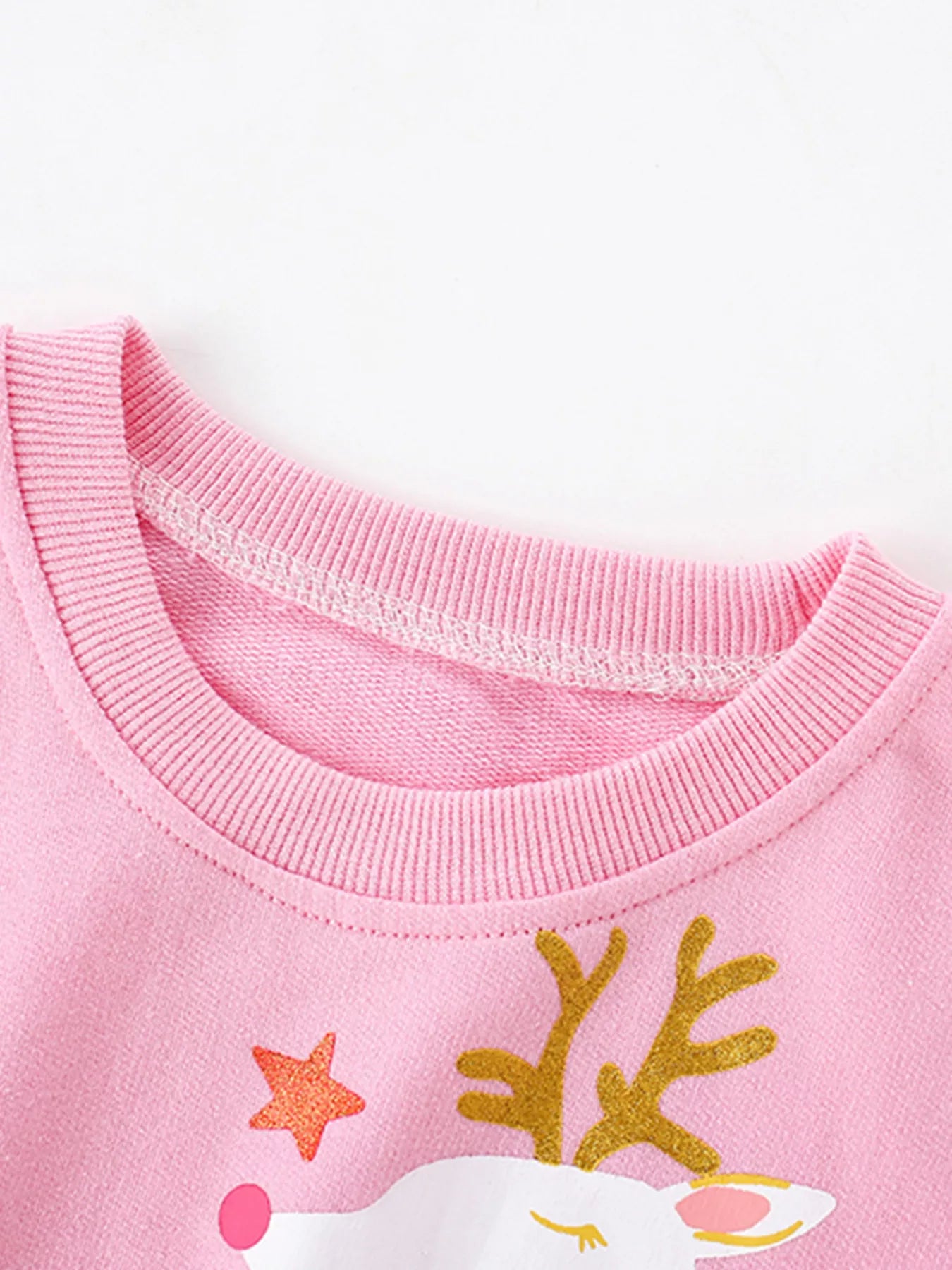 Cute holiday pink cotton sweatshirt with reindeer graphic and star details.