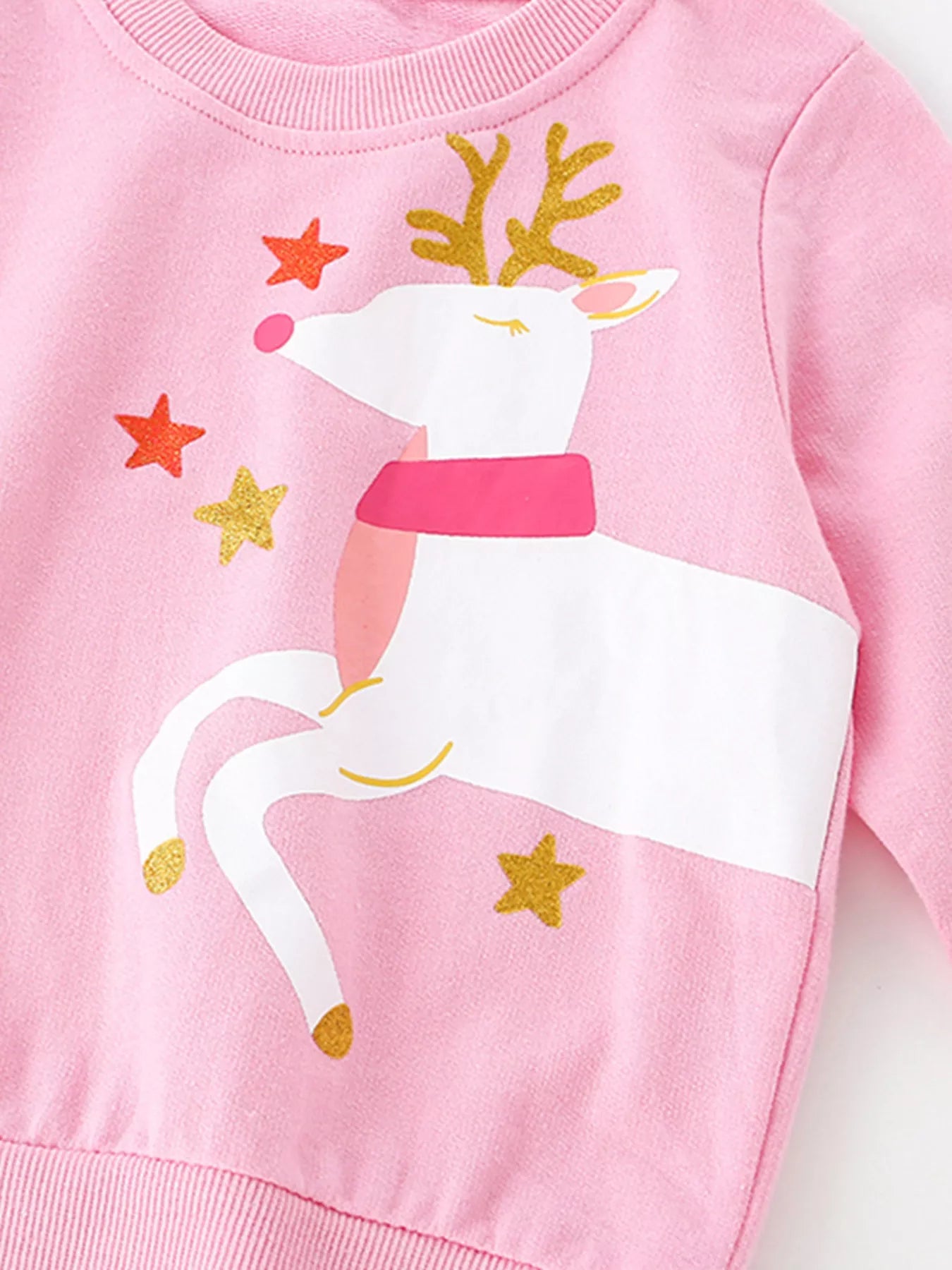 Cute holiday pink cotton sweatshirt with reindeer graphic and star details.