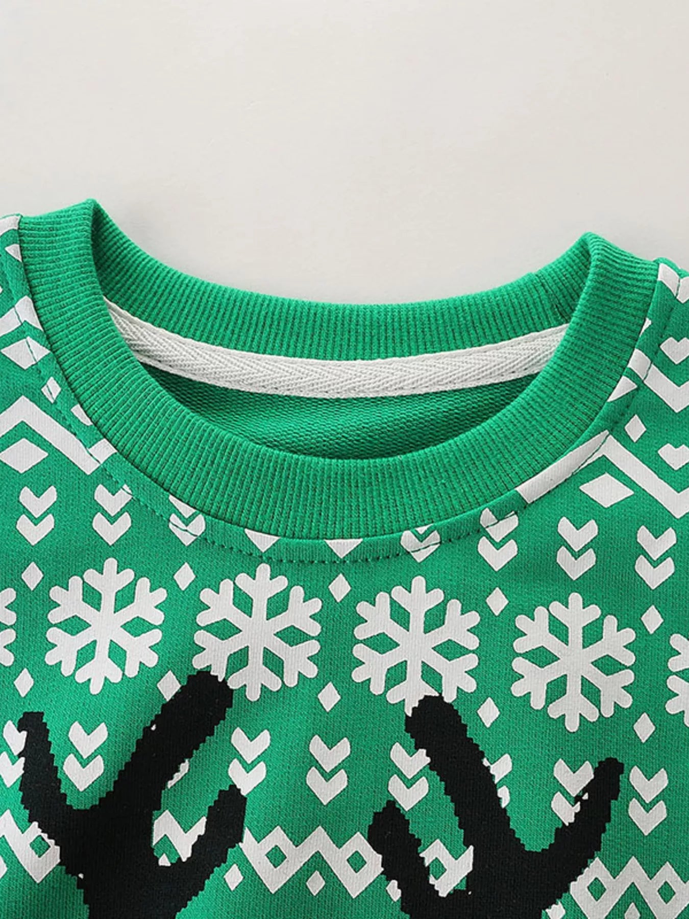 Green kids Christmas sweatshirt with a cool reindeer wearing sunglasses and white snowflake patterns.