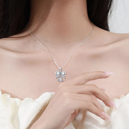 Close-up of Twinkling Holiday Bow Bell Moissanite Necklace with 0.5ct stone and delicate chain.