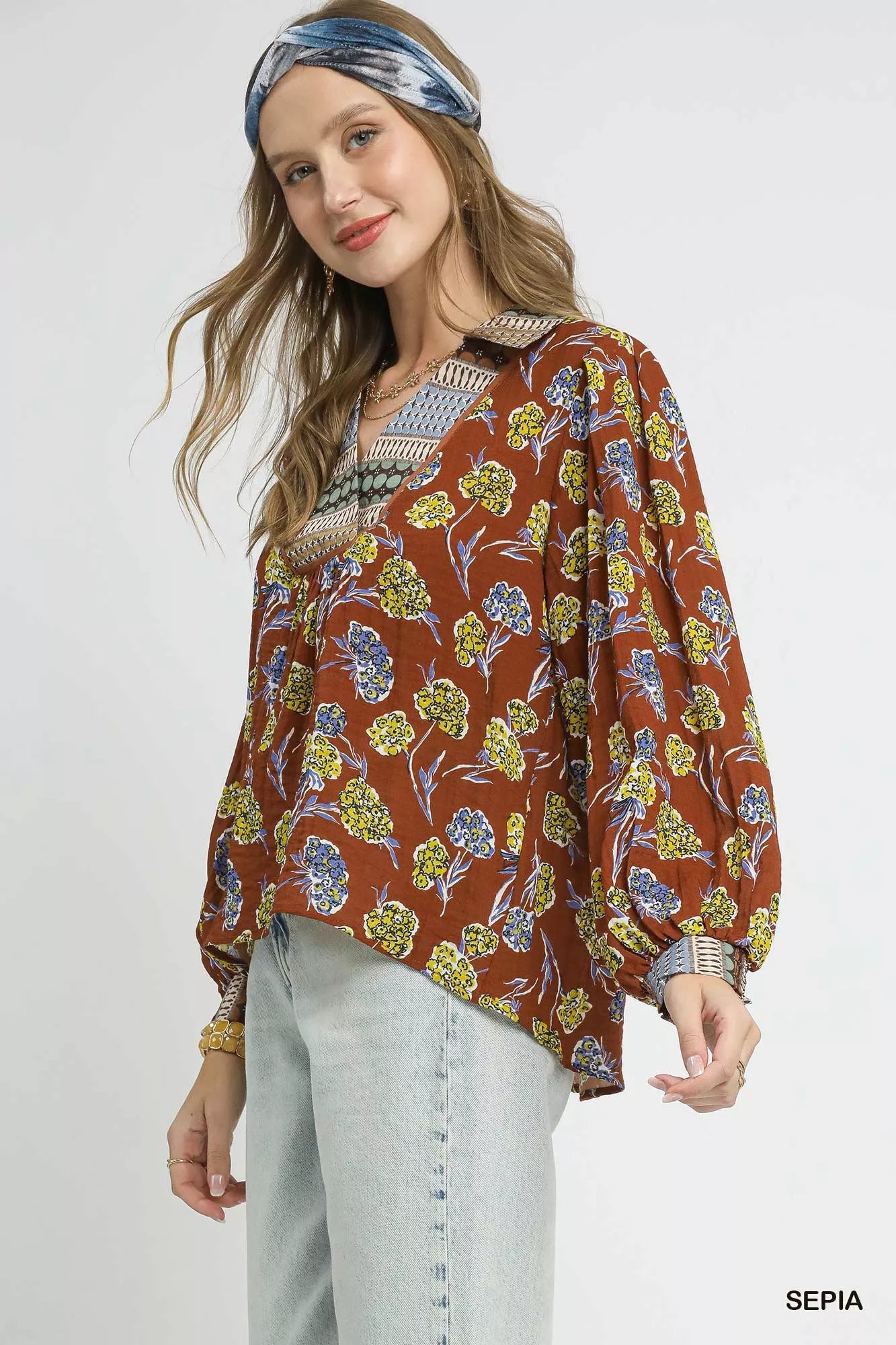 Boho floral print blouse in warm brown with contrast collar, long balloon sleeves, and relaxed fit on model