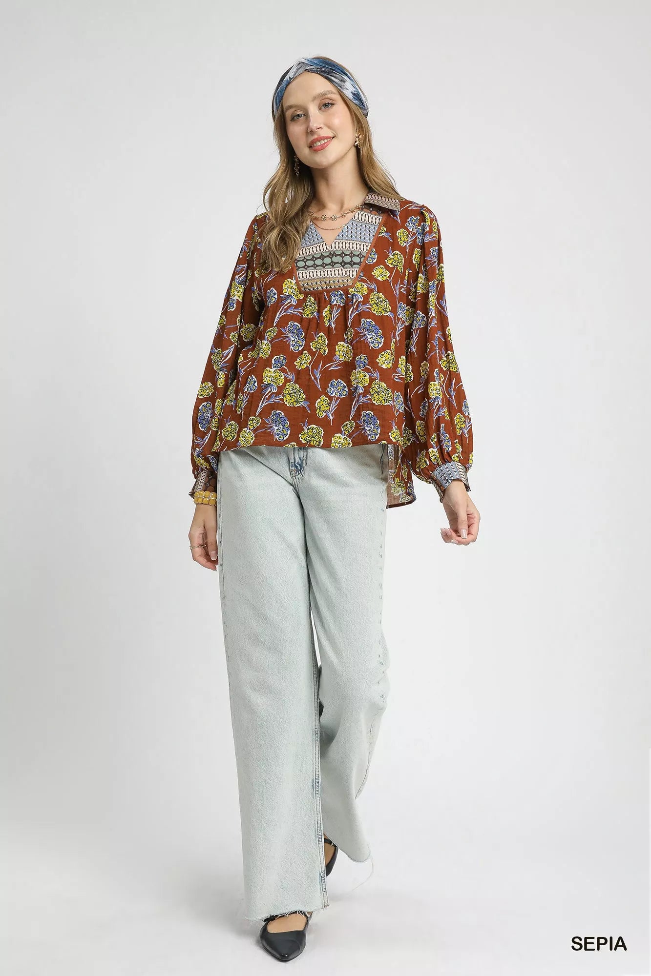 Boho floral print blouse in warm brown with contrast collar, long balloon sleeves, and relaxed fit on model
