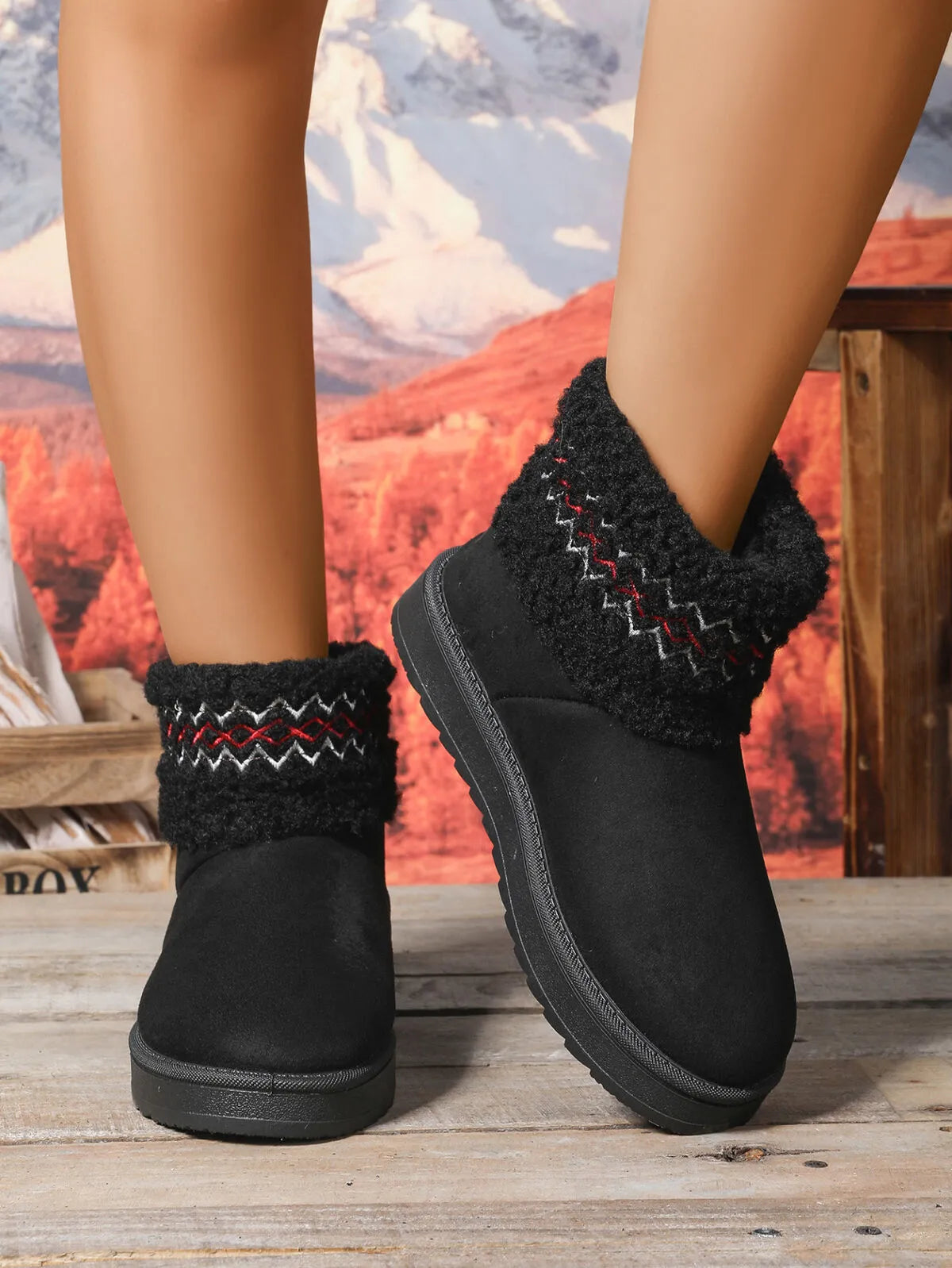 Woman wearing knit cuff winter booties in black, tan, and cream — cozy cold-weather shoes from A Whimsical Affair.
