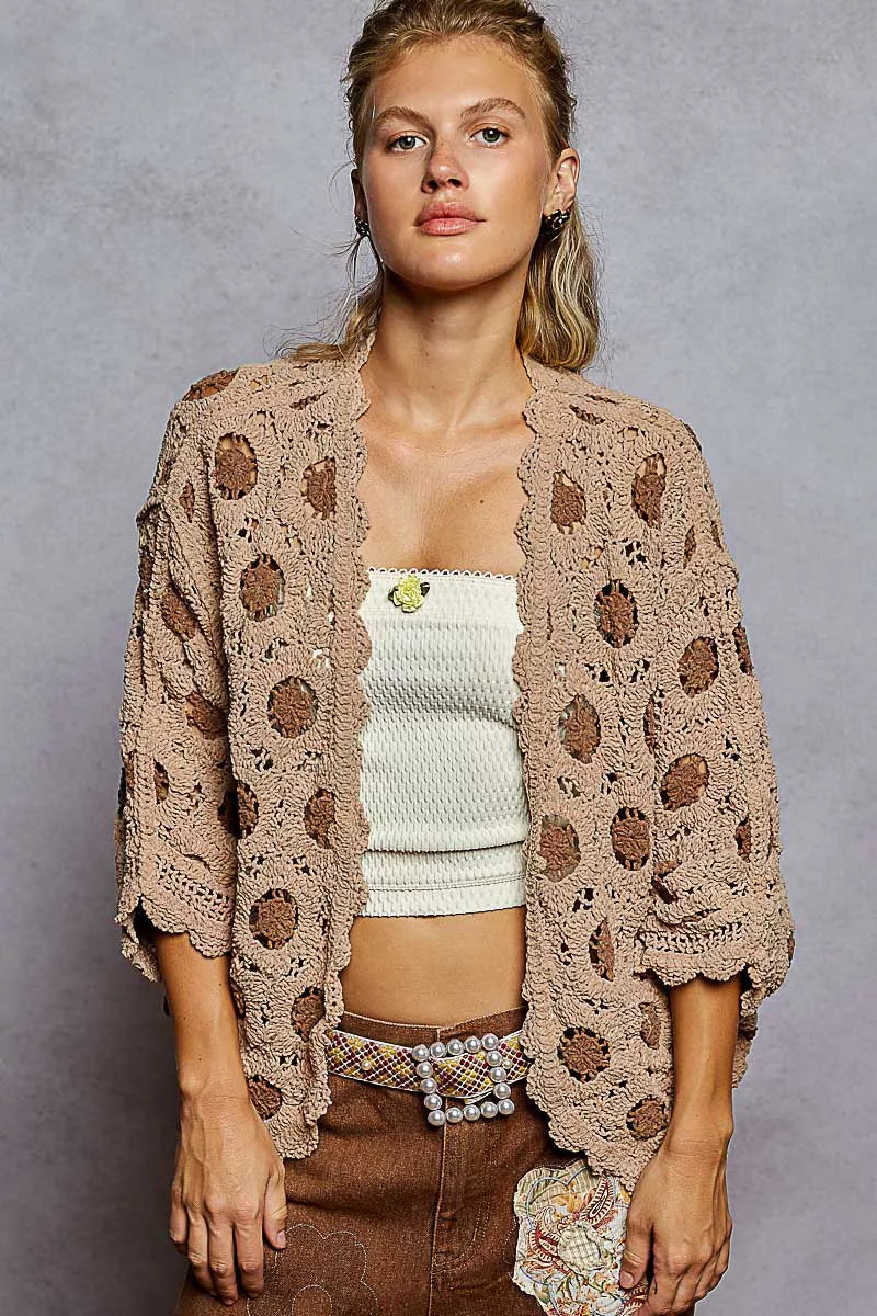 Brown crochet chenille cardigan with floral pattern and relaxed batwing fit.