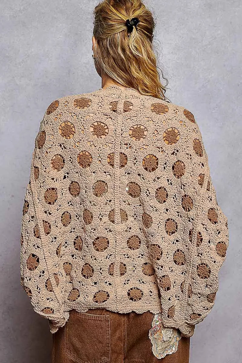 Brown crochet chenille cardigan with floral pattern and relaxed batwing fit.