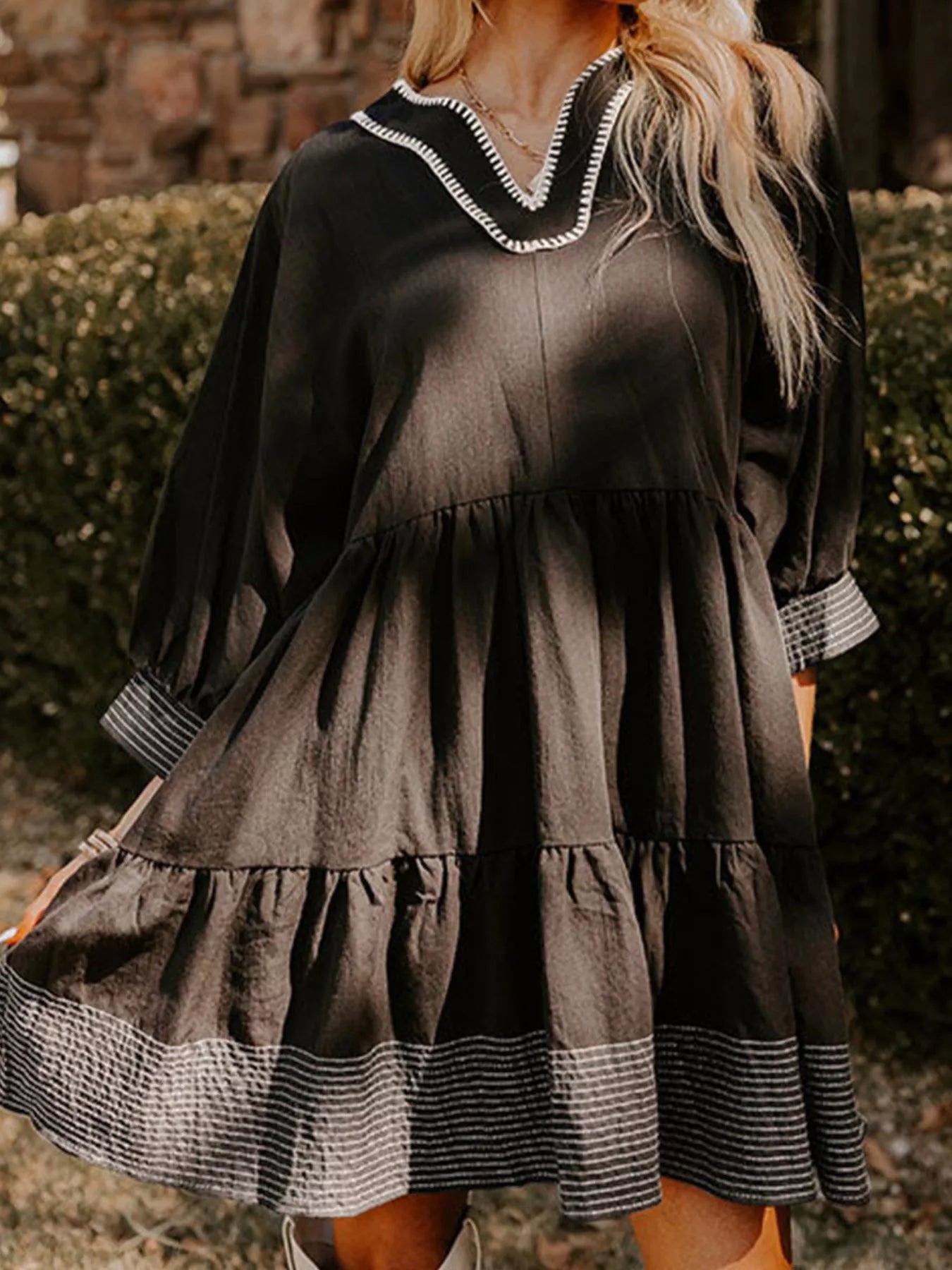 Woman wearing brown Autumn Ease Tiered Dress with 3/4 sleeves and striped hem