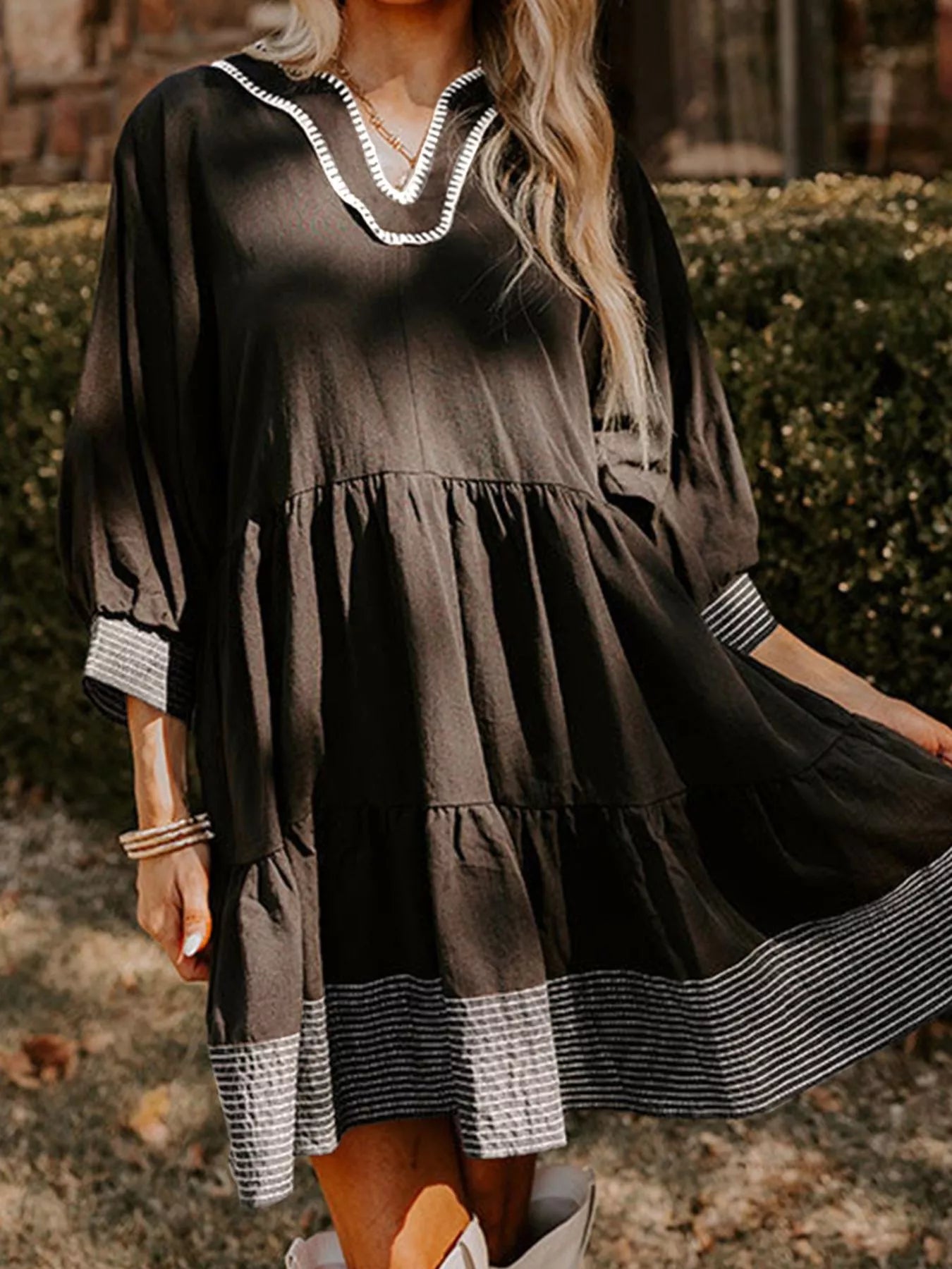 Woman wearing brown Autumn Ease Tiered Dress with 3/4 sleeves and striped hem