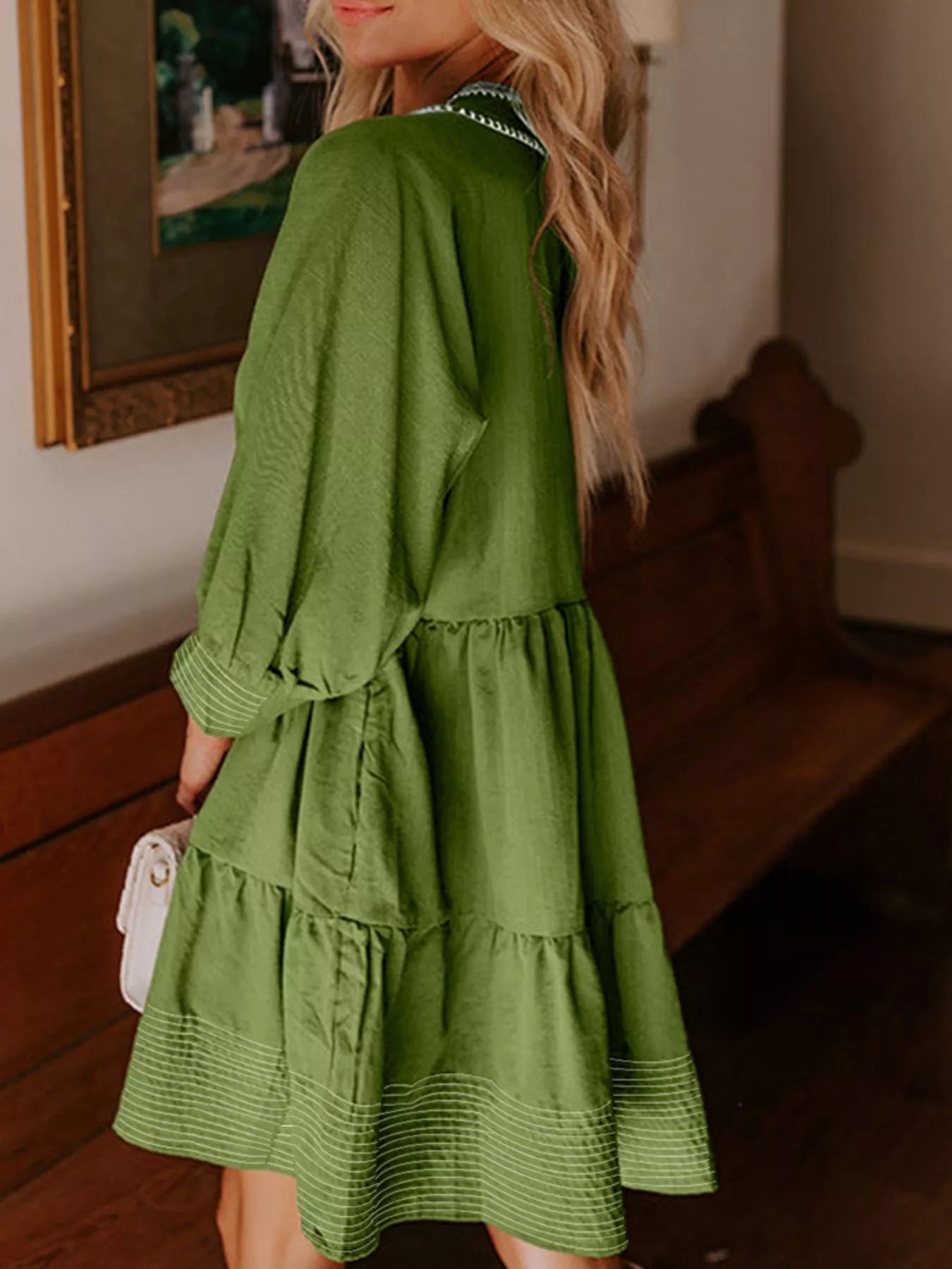 Woman wearing green Autumn Ease Tiered Dress with 3/4 sleeves and striped hem