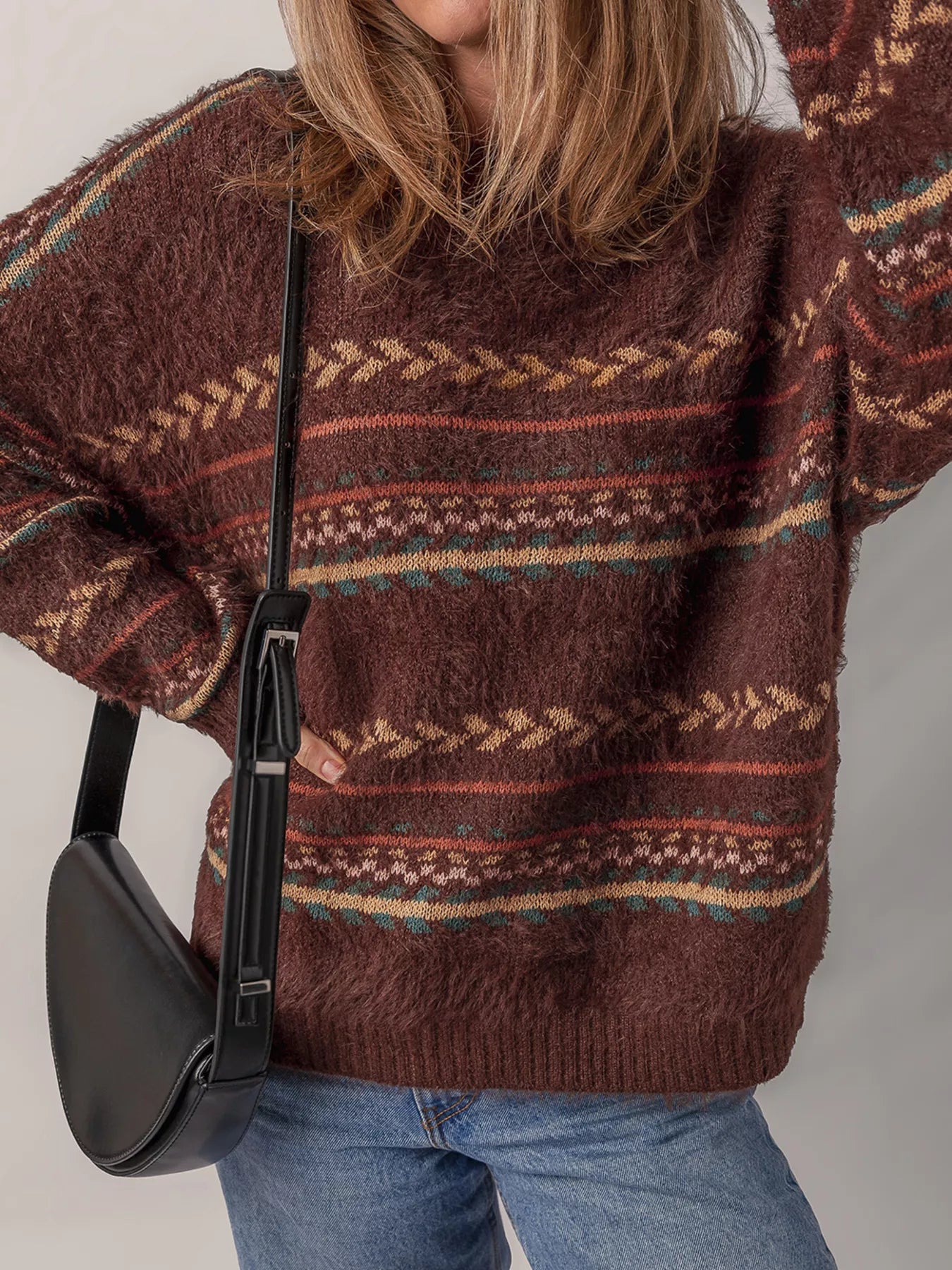 Brown oversized fuzzy sweater with fair isle-style stripes in warm earthy tones.