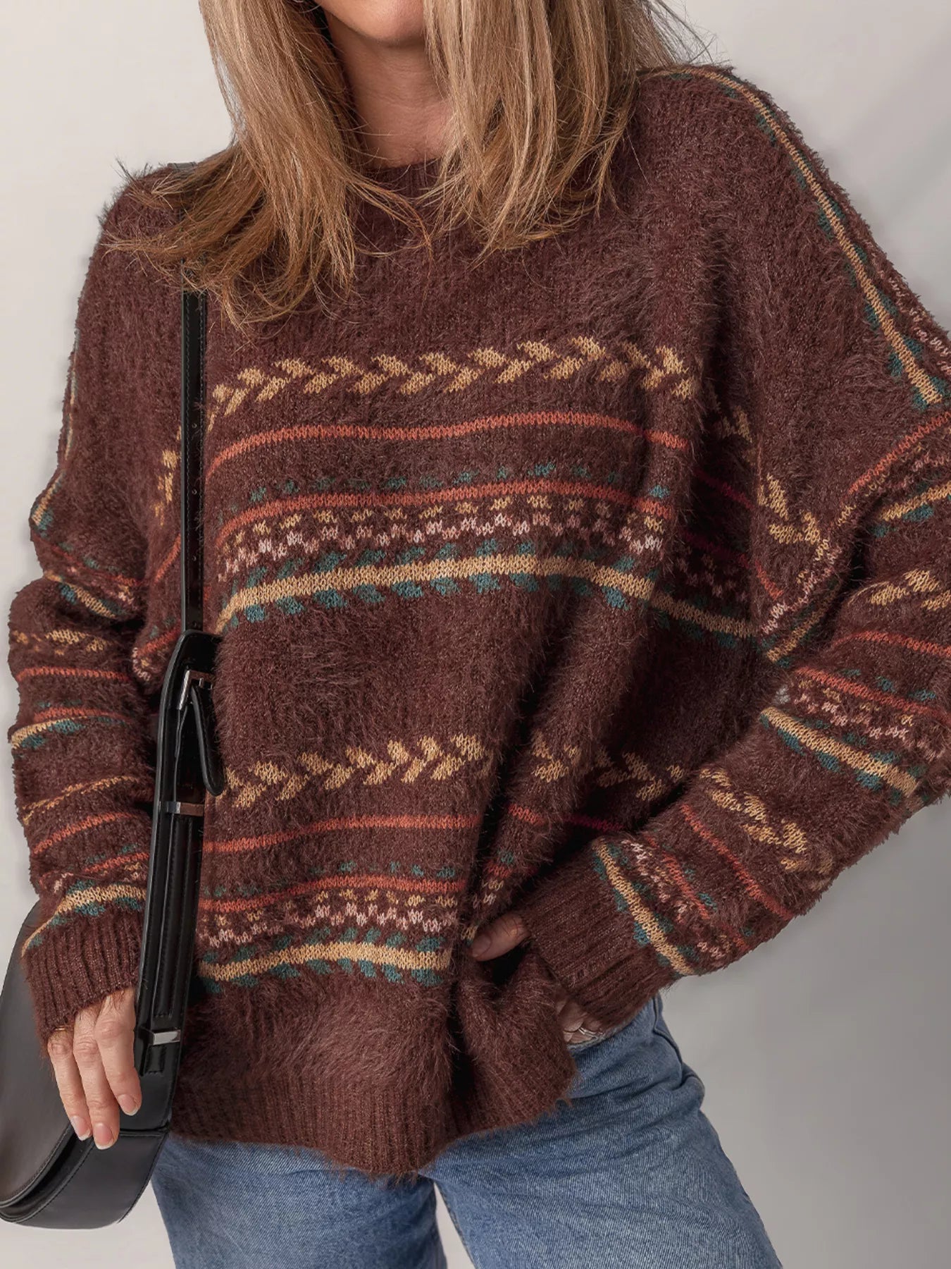 Brown oversized fuzzy sweater with fair isle-style stripes in warm earthy tones.