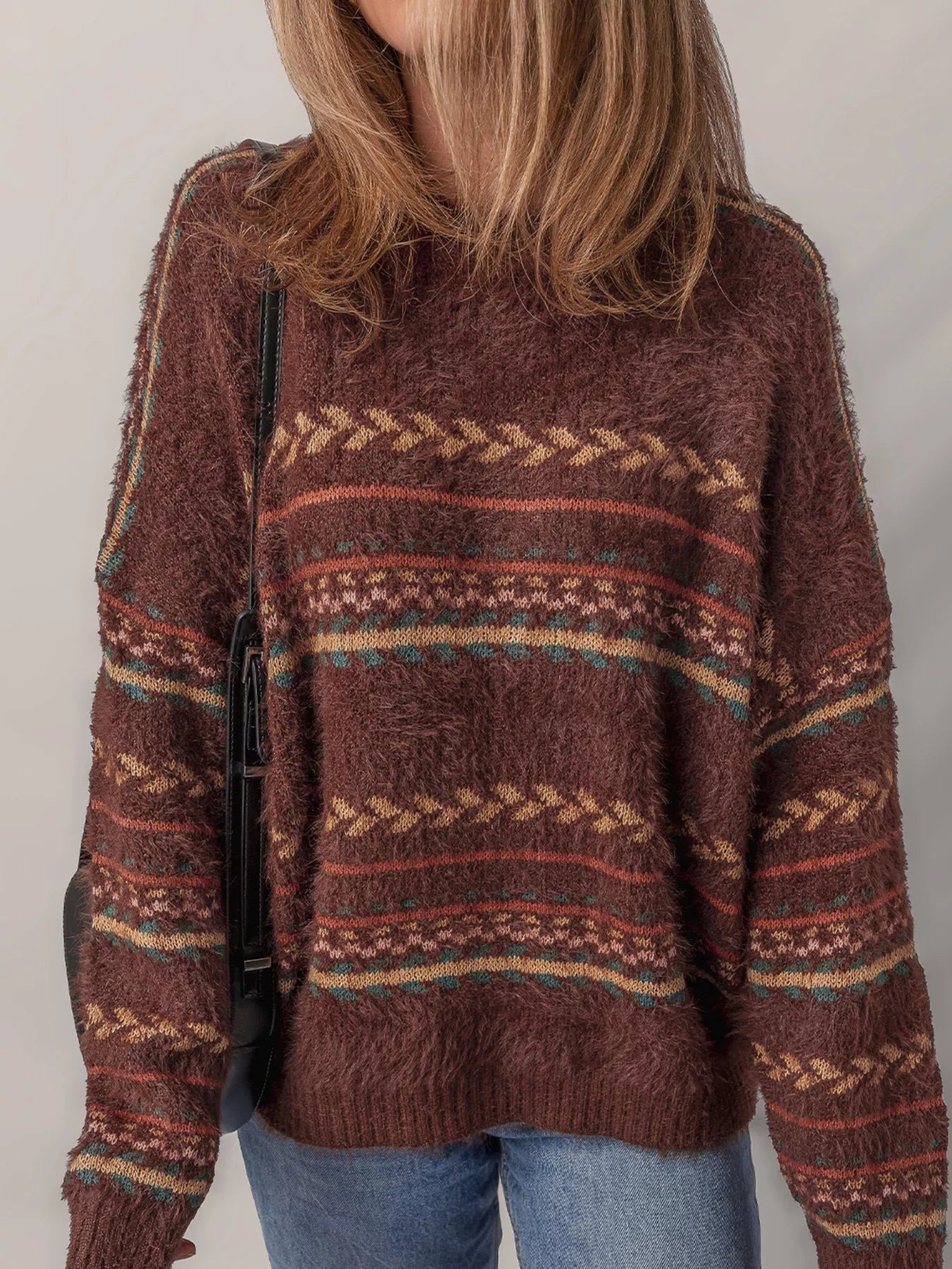 Brown oversized fuzzy sweater with fair isle-style stripes in warm earthy tones.
