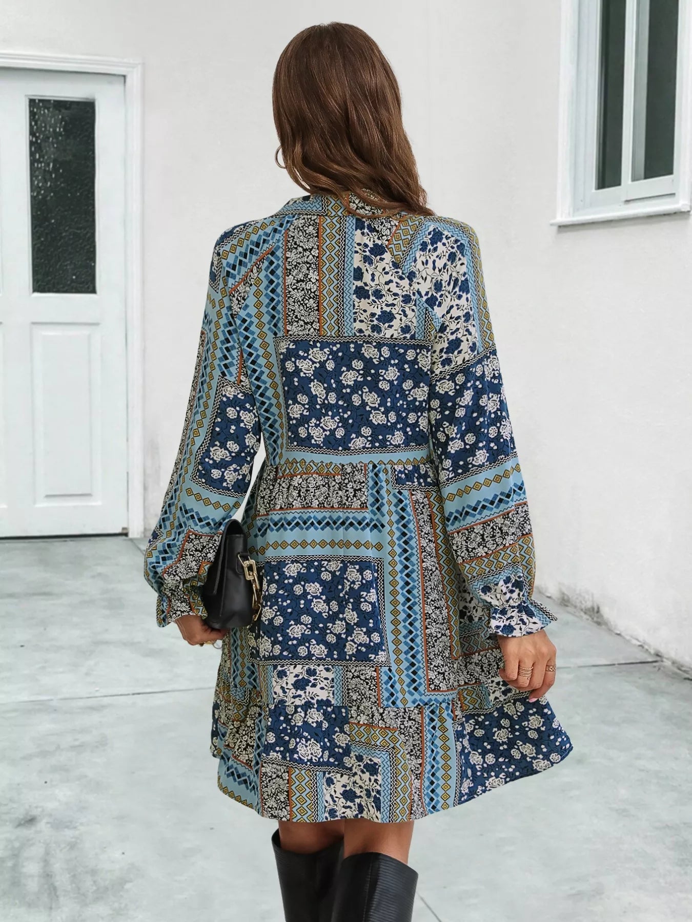 Patchwork long sleeve mini dress with ruffled hem and boho-inspired print