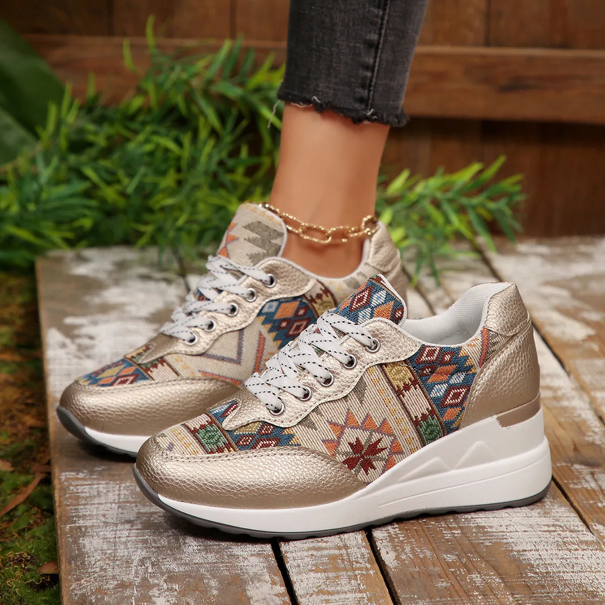 A pair of Aztec Rise Wedge Sneakers with colorful geometric patterns, lace-up design, and hidden wedge heel in cream and khaki color options