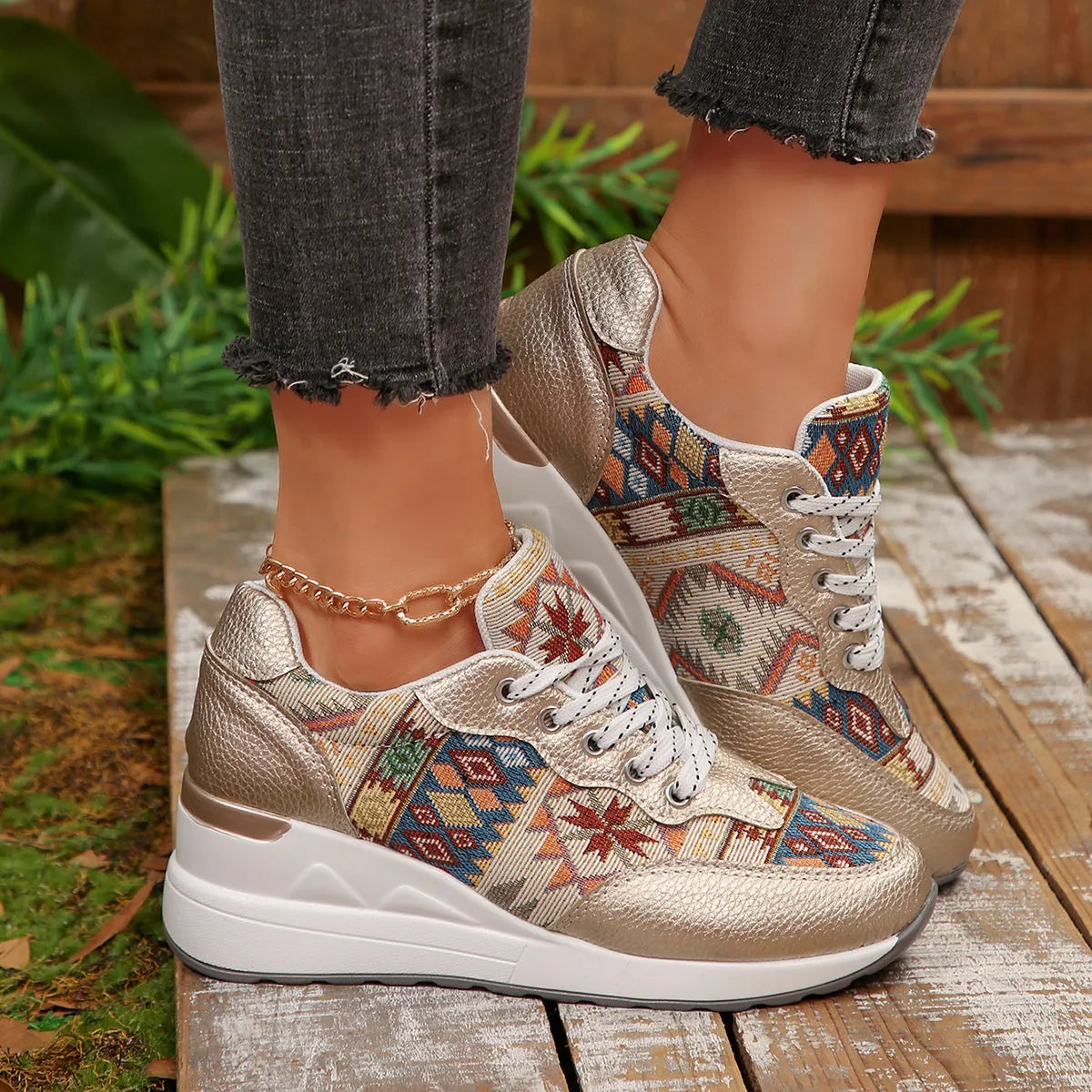 A pair of Aztec Rise Wedge Sneakers with colorful geometric patterns, lace-up design, and hidden wedge heel in cream and khaki color options