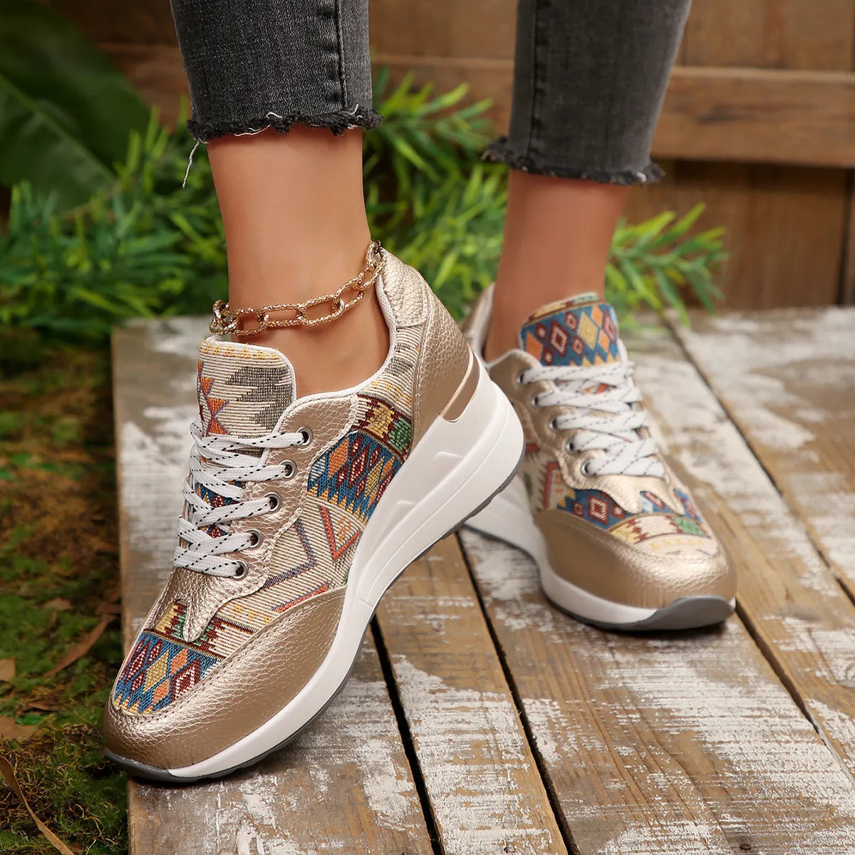 A pair of Aztec Rise Wedge Sneakers with colorful geometric patterns, lace-up design, and hidden wedge heel in cream and khaki color options
