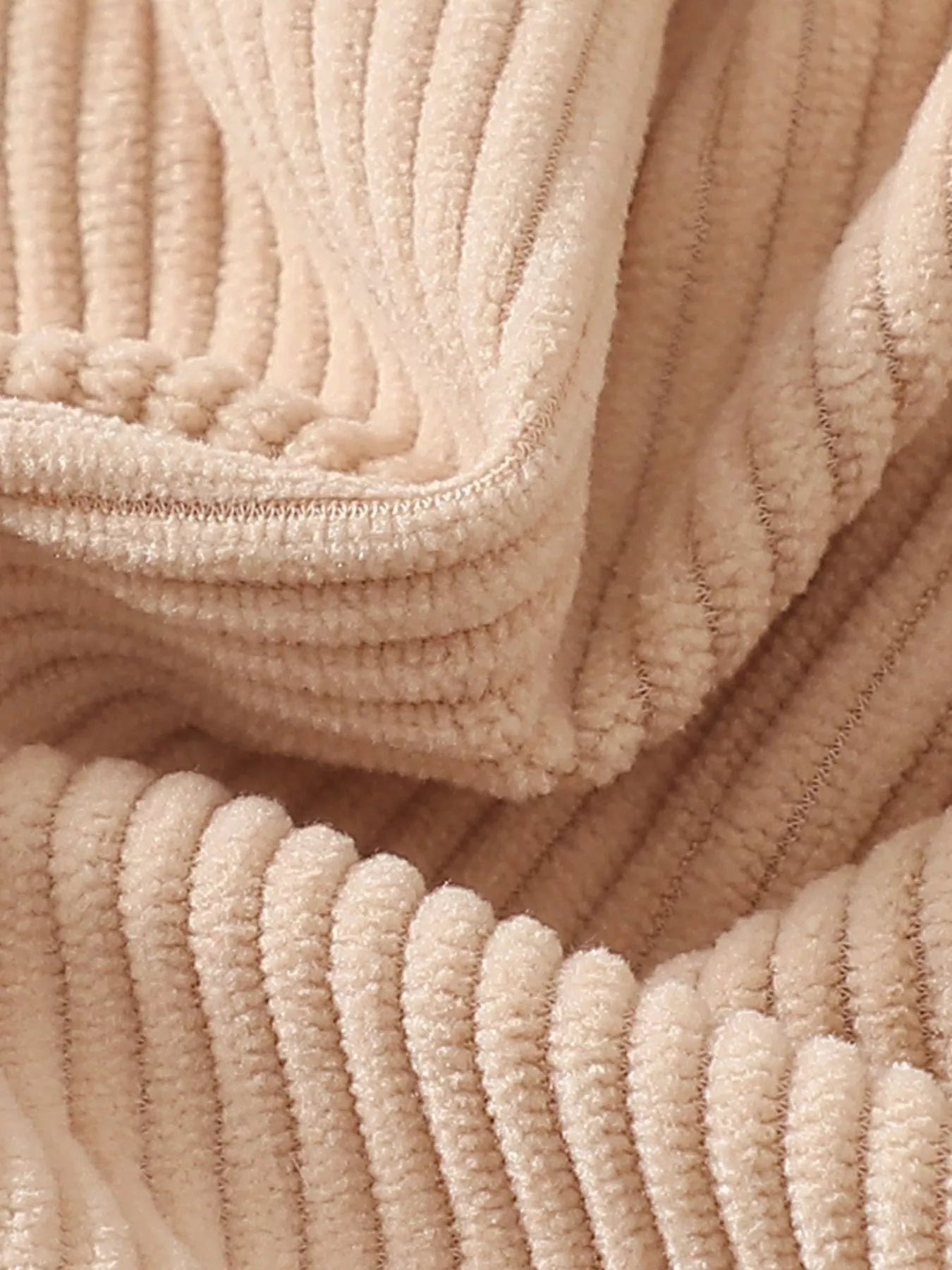 Cream ribbed corduroy baby romper with button straps, snap bottom, and textured chicken appliqué on the front.