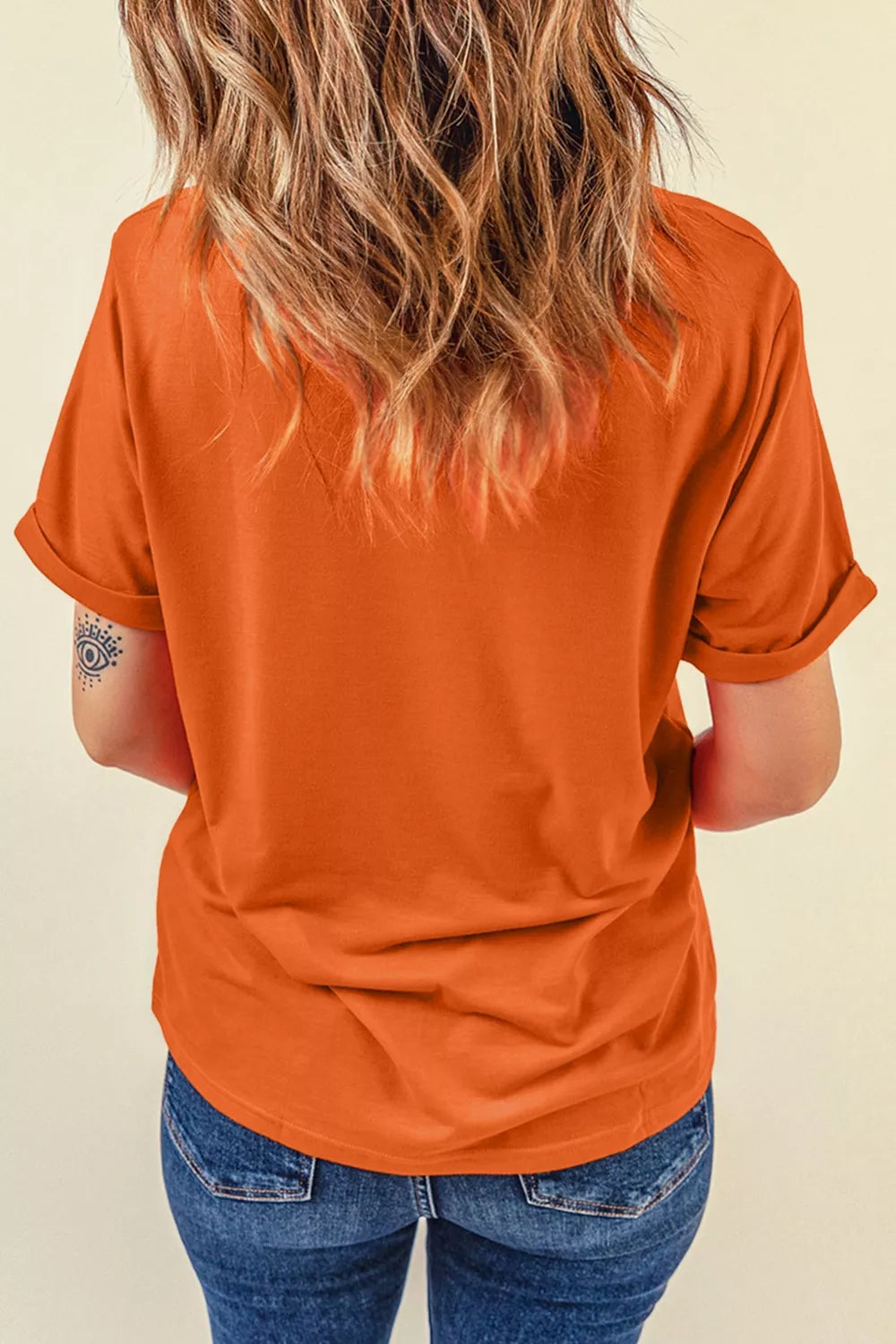 Orange short sleeve graphic tee with stacked patchwork-style farm animals including a cow, pig, sheep, and chicken.