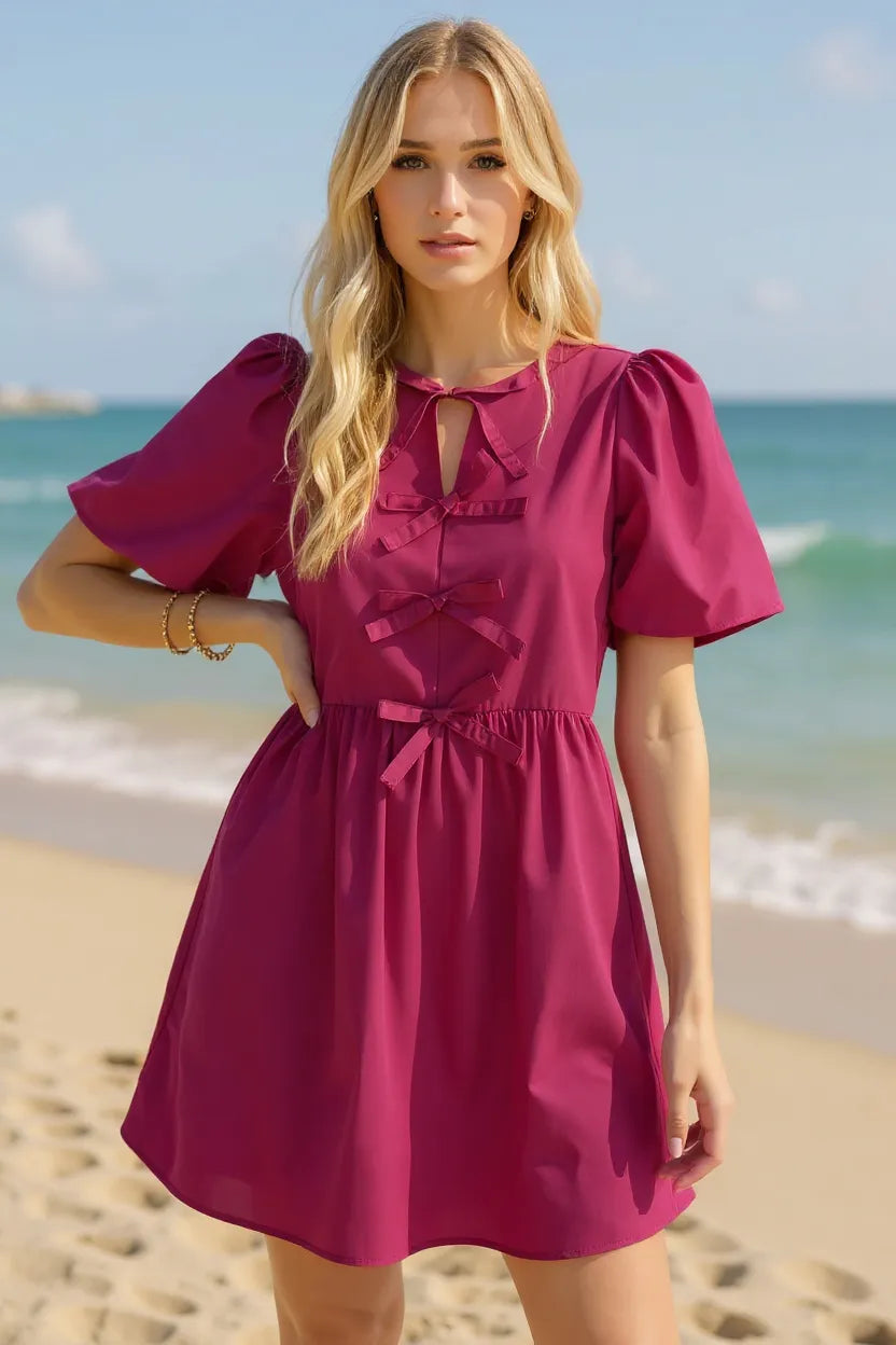 Berry pink mini dress with bow front detail and puff sleeves