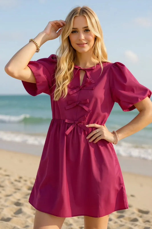 Berry pink mini dress with bow front detail and puff sleeves