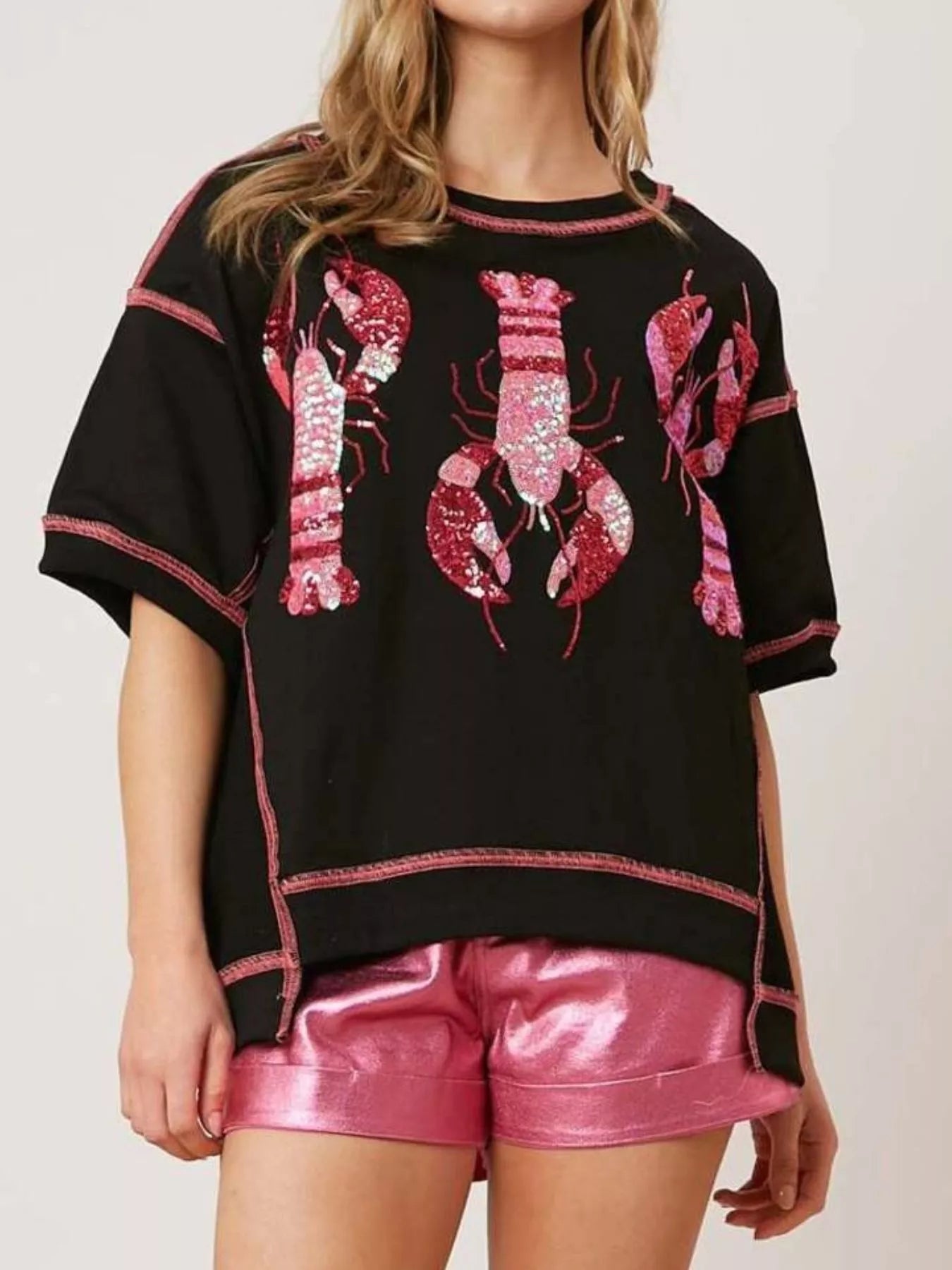 Oversized black tee with pink glitter lobster print and contrast stitching.