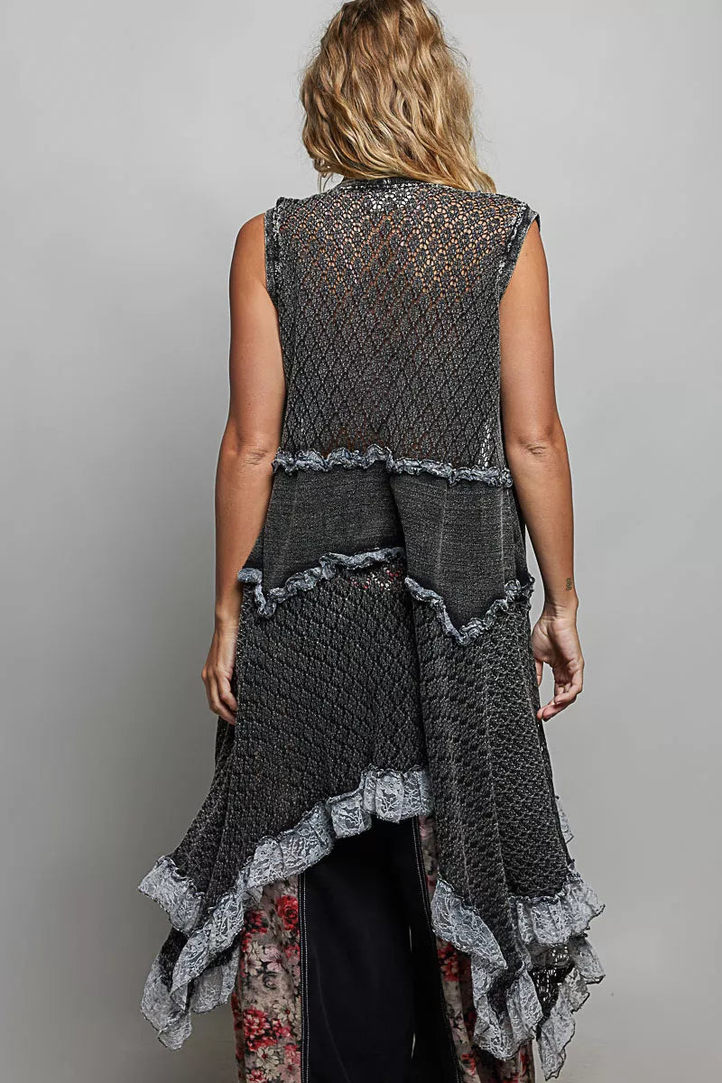 Sleeveless crochet vest with openwork texture, lace details, cascading ruffle hem, and lightweight boho layering style.
