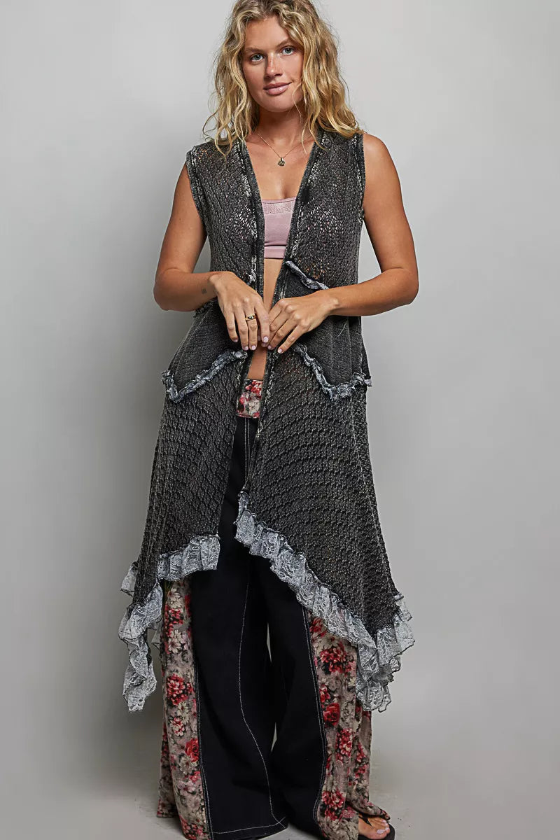 Sleeveless crochet vest with openwork texture, lace details, cascading ruffle hem, and lightweight boho layering style.