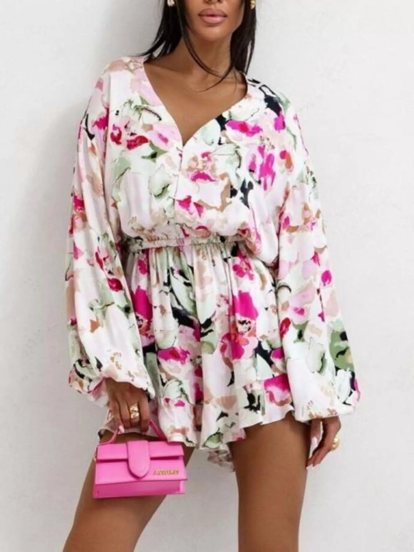 Bloom & Breeze Romper in white and pink floral print with long sleeves and elastic waist.