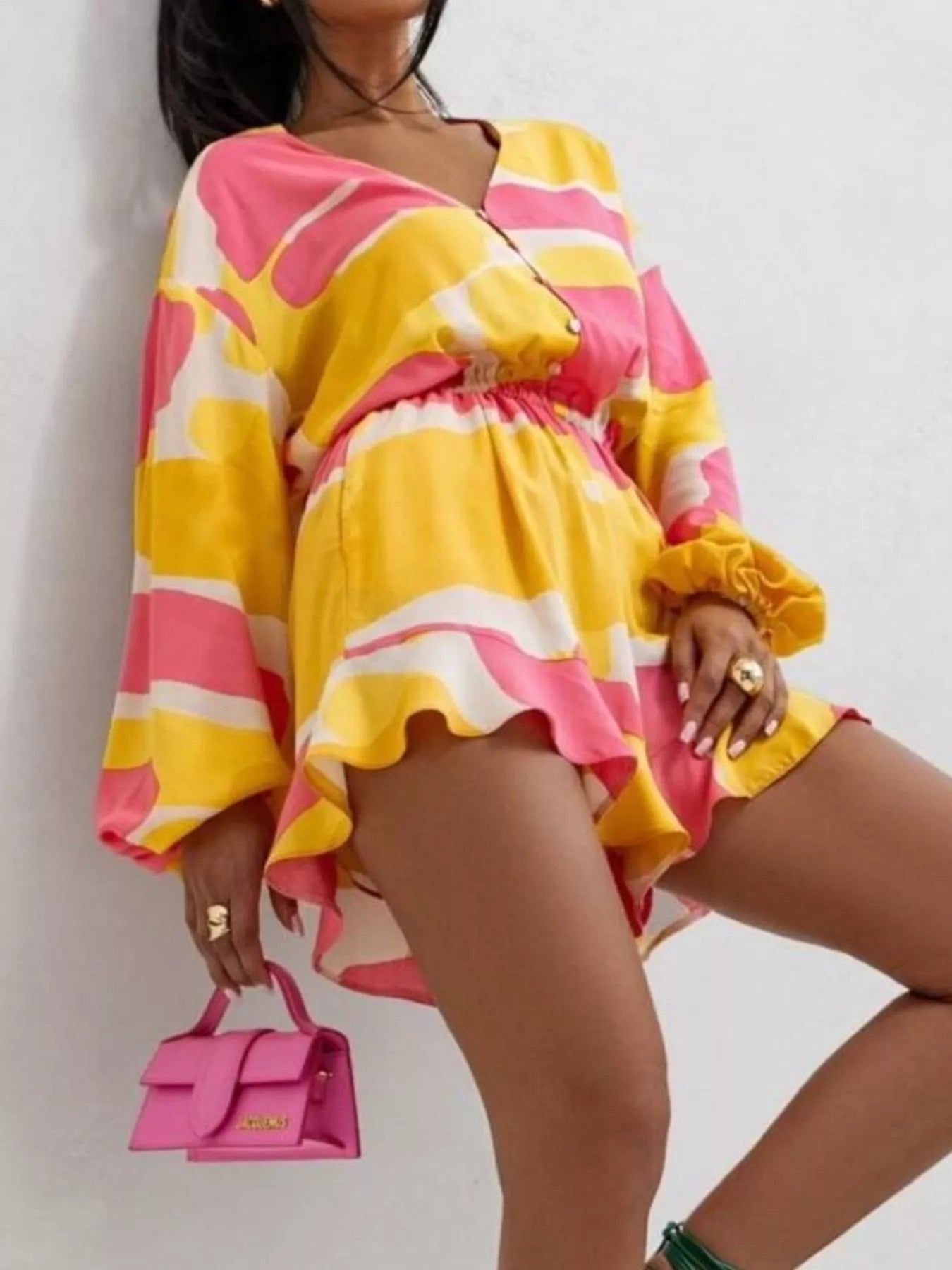 Bloom & Breeze Romper in bold yellow and pink abstract print with ruffle detail.