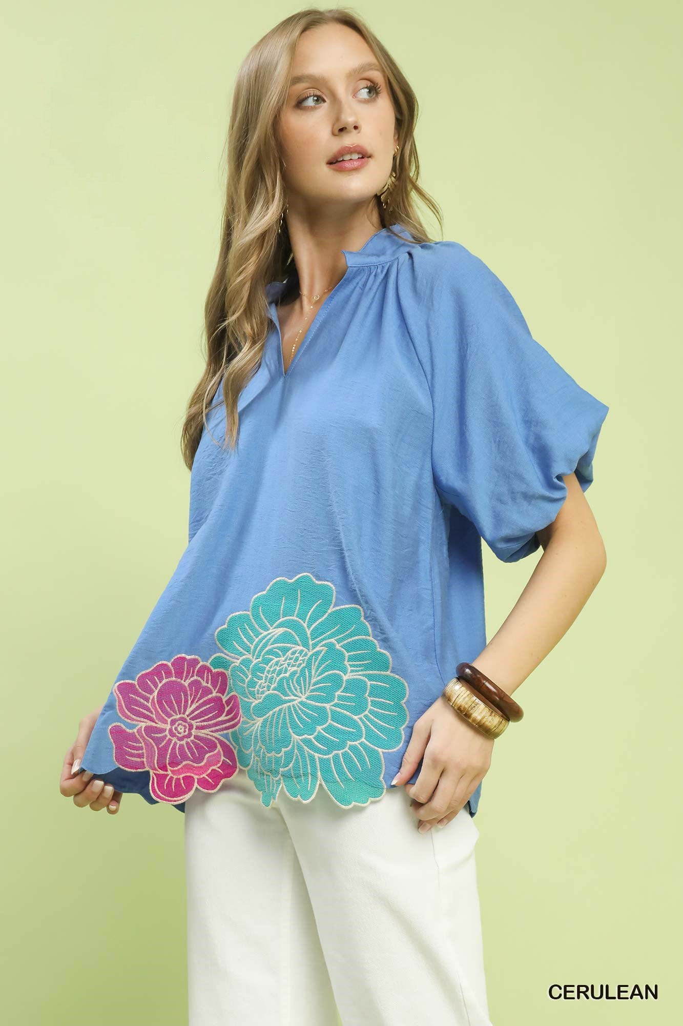 Blue relaxed top with oversized floral embroidery at hem