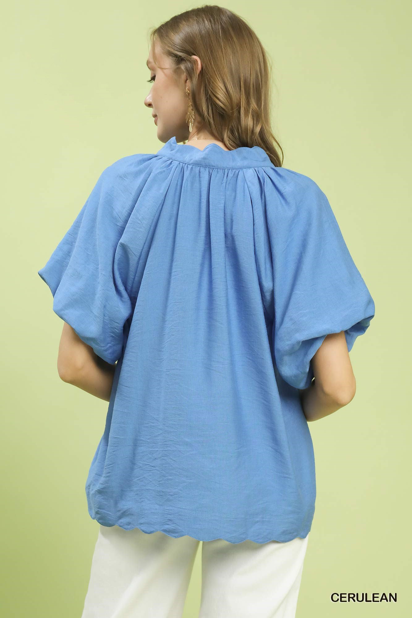 Blue relaxed top with oversized floral embroidery at hem