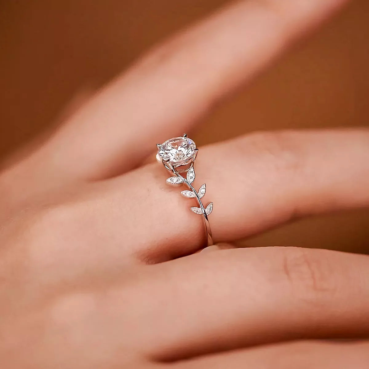 Blooming Rose Sterling Silver Ring with zircon centerpiece and delicate leaf accents on finger